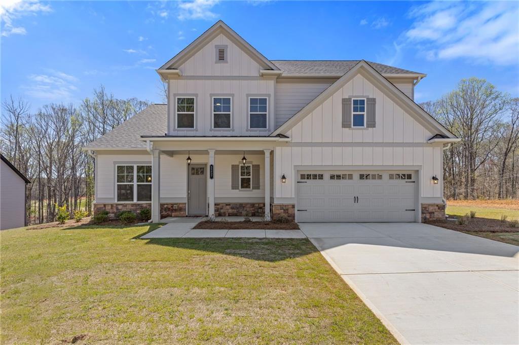Welcome to your dream home at 3257 Traditions Way, a beautifully crafted Jamestown plan nestled in the prestigious Traditions of Braselton community. This exquisite new construction offers five spacious bedrooms and four full baths within a thoughtfully designed open-concept layout that blends timeless elegance with modern comfort. The heart of the home features a chef-inspired kitchen with granite countertops, stainless steel appliances, a large center island, and a walk-in pantry—perfectly positioned to overlook the fireside family room and sunlit dining area. A main-level bedroom and full bath provide flexible space for guests or a private office. Upstairs, retreat to the luxurious primary suite complete with a sitting area, expansive walk-in closet, and spa-like bath with dual vanities, a soaking tub, and a stunning mega shower. Enjoy outdoor living on the covered patio overlooking a serene backyard. Residents of Traditions of Braselton enjoy resort-style amenities including an Olympic-sized pool with water slide, fitness center, clubhouse, tennis and pickleball courts, walking trails, and an 18-hole golf course, all set within a vibrant and beautifully maintained master-planned community. This is a new construction home. Photos and finishes are representative and may not reflect the actual home.