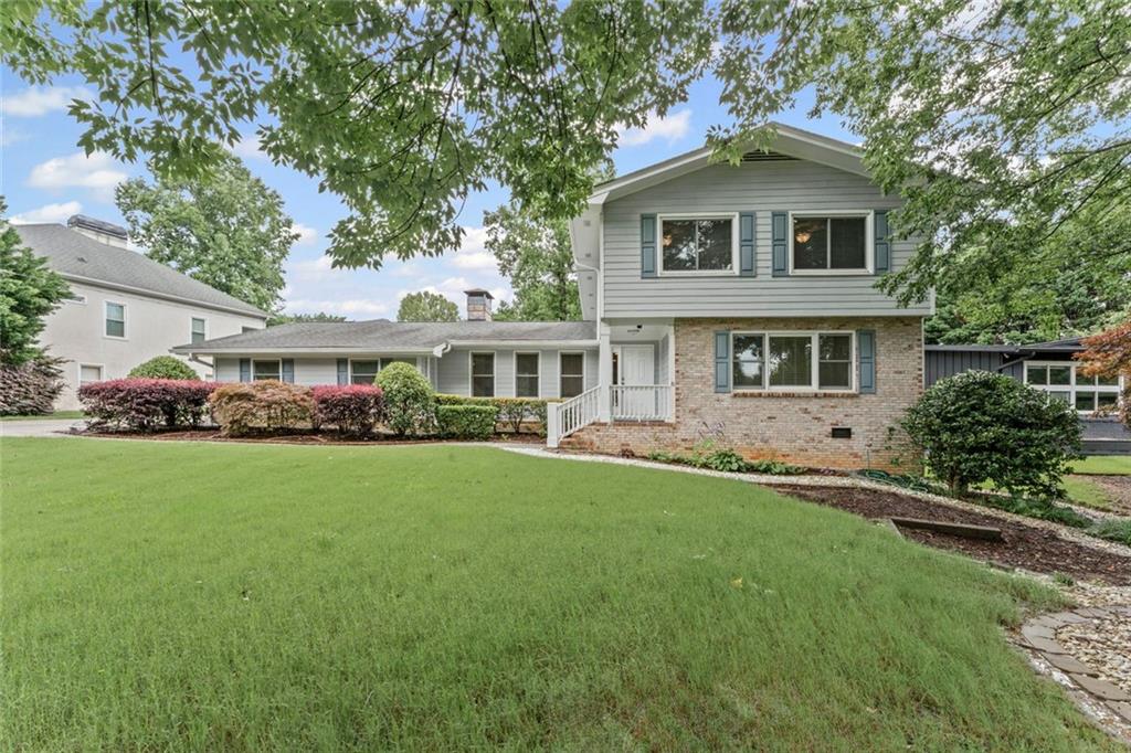 Tucked into one of Dunwoody’s most beloved neighborhoods, this 4-bedroom, 3.5-bathroom home blends spacious living, smart function, and touches of charm both inside and out—with energy-efficient upgrades that add even more value and peace of mind.
Step through the front door into a main level designed for both comfort and versatility. The heart of the home, the living room welcomes you with vaulted ceilings, a wood-burning fireplace, and warm natural light that spills in from every direction. The updated kitchen—equipped with stainless steel appliances, a wall of pantry cabinetry, and plenty of counter space—opens easily to the living, dining room, and sunroom areas, making this space as practical as it is inviting.
Just off the entry and living room, a generous office with built-ins and a double closet offers the perfect work-from-home setup—whether you need quiet focus, ample storage, or a space that can evolve with your needs. Also on the main level, but tucked in the back of the home for privacy, a full bedroom and bathroom create the ideal guest retreat or second primary suite, offering flexibility for multigenerational living.
The sunroom is one of those spaces that immediately makes you exhale. Bright and tranquil, it looks out over the backyard and leads directly to the patio. Just off the sunroom is a fully conditioned workout room with its own access to the yard—great for early-morning yoga or sneaking in a quiet moment to yourself.
Upstairs, the primary suite feels like a true retreat, featuring two walk-in closets, beautiful natural light, and a spacious en suite with dual vanities, a jetted tub, separate shower, private water closet, and even heated floors for a touch of everyday luxury. Two additional bedrooms share a well-appointed hall bathroom with dual vanity and a tub/shower combo.
Throughout the home, hardwood and tile flooring bring style and durability, while plush carpet in the bedrooms adds a cozy touch.
Outside, enjoy a terraced backyard with plenty of flat space to play, garden, or relax—surrounded by a bounty of fruit trees and bushes, including blueberries, raspberries, peaches, and figs. Whether you’re roasting marshmallows in the landscaped front yard fire pit area or harvesting fruit in the backyard, there’s always a reason to be outside.
This home isn’t just comfortable—it’s consciously designed. Solar panels reduce energy costs while helping the environment, and a tankless water heater ensures endless hot water with efficiency. The Tesla Powerwall battery backup provides seamless power during outages, delivering modern peace of mind in a beautifully classic setting.
Nestled in a neighborhood loved for its top-rated schools, proximity to interstates, shopping, and dining, and an optional swim/tennis club that brings neighbors together all summer long, this home is more than just a place to live—it’s a home designed for living well.