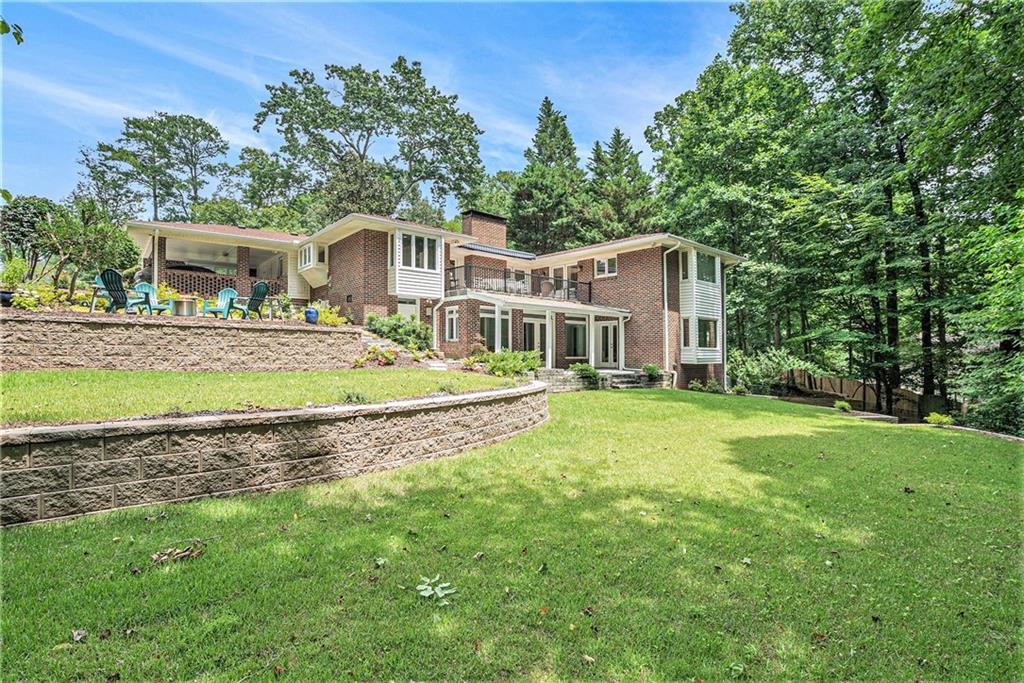 Tucked away on a serene ¾ +/- acre cul-de-sac lot in the sought-after Oak Grove Elementary and Lakeside High School district, this exceptional ranch home offers a rare combination of space, flexibility, and thoughtfully curated design across two fully finished levels. Boasting 6 bedrooms and 3 full baths, this residence is perfect for multigenerational living, entertaining, or simply enjoying generous room to spread out. The elegant front-entry foyer welcomes you into sunlit living spaces, where large windows and a seamless layout create an airy, inviting feel. The main living and dining areas connect effortlessly to a private office/study, while a charming Great Room—highlighted by vaulted ceilings, skylights, a masonry fireplace, and dual French doors—opens to a large balcony ideal for morning coffee or sunset cocktails. The French farmhouse style eat-in kitchen is a chef’s delight, featuring abundant cabinetry, premium appliances (wolf induction stove top, subzero fridge and new fancy double ovens), and smart connectivity to the entertaining spaces. The main-level primary suite is a peaceful retreat with French doors leading to the balcony with a retractable awning. The spa-inspired bath boasts a soaking tub, separate shower, and double vanity—a perfect escape at the end of the day. Two additional bedrooms and a full hall bath complete the main level. Downstairs, the fully finished terrace level offers unmatched versatility with three more bedrooms, a full bath, a spacious recreation/game room, cozy media area, and an additional office. Amazing craftsman ceiling details! A refreshment kitchenette and walk-in wine closet elevate the space for entertaining or everyday comfort. Outside, the professionally landscaped, three-tiered backyard is a true showstopper, featuring beautifully constructed Allen block retaining walls, a designer stone patio ideal for an outdoor fireplace, slate walkways and wired evening lighting that creates magical ambiance. Bonus features include a 728 sq ft exterior-entry storage room—perfect for tools, hobbies, or a workshop—and even a dog wash tub for your four-legged (owner approved) family members. This is more than a home—it's a lifestyle. Thoughtfully designed, impeccably maintained, and perfectly located, this ranch retreat is ready to welcome you. Lease purchase considered if interested. General yard maintenance is included.