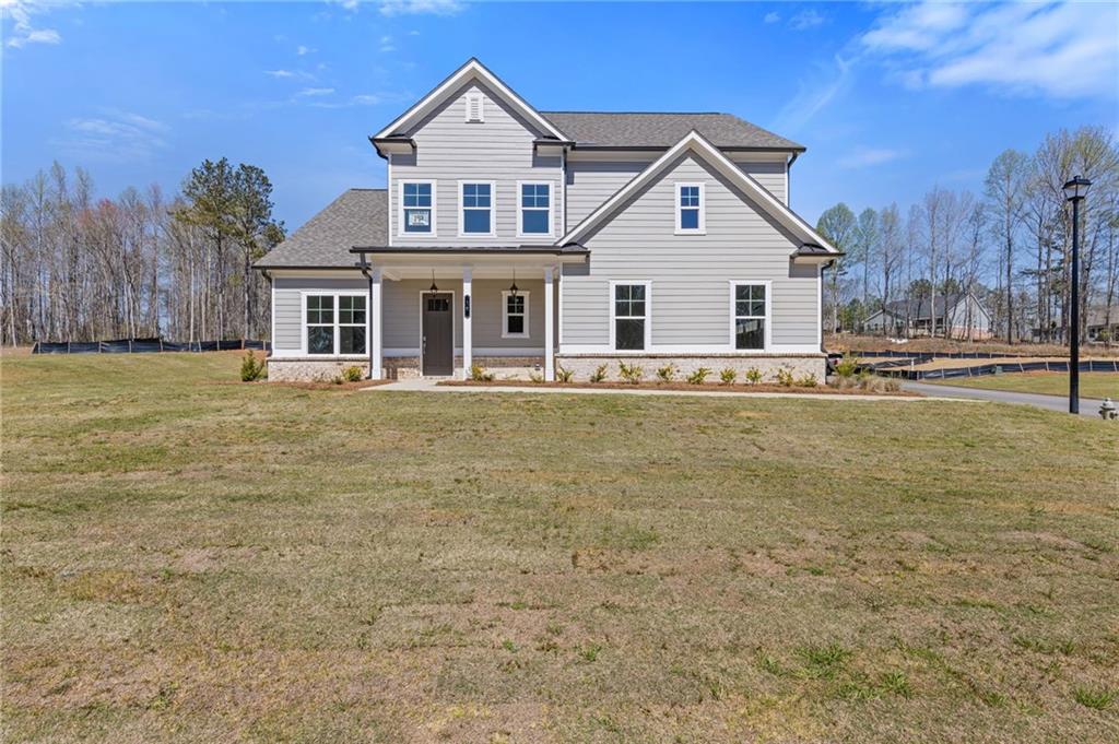 Welcome to 15 Overview Court, Jefferson, GA 30549 — a beautifully designed Jamestown plan situated in the prestigious Traditions of Braselton community. This spacious home offers five bedrooms and four full bathrooms with an open and thoughtfully crafted layout ideal for modern living. The main level features a gourmet kitchen with granite countertops, stainless steel appliances, a large island, and a walk-in pantry that opens to a bright breakfast area and cozy fireside family room. A versatile main-level bedroom and full bath provide a perfect space for guests or a private office. Upstairs, the expansive primary suite offers a serene retreat with a sitting area, oversized walk-in closet, and a spa-inspired bathroom with dual vanities, a soaking tub, and a separate mega shower. Three additional bedrooms and two full baths complete the upper level. Enjoy outdoor living on the covered patio overlooking a peaceful backyard. Residents of Traditions of Braselton enjoy exceptional amenities including an Olympic-sized pool with water slide, clubhouse, fitness center, tennis and pickleball courts, walking trails, and an 18-hole golf course in one of Jackson County’s most sought-after communities. This is a new construction home. Photos and finishes are representative and may not reflect the actual home.
