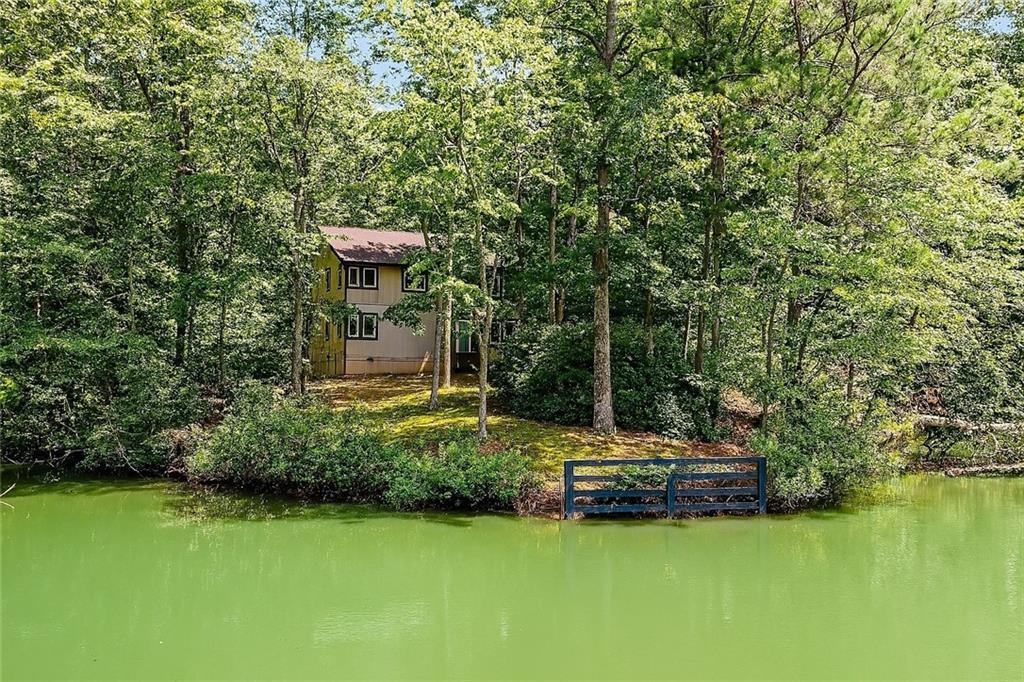1.2 Acre Lakefront Home in Milton – Top-Rated Schools!
Welcome to 13370 Providence Park Drive – a charming craftsman-style home in the highly sought-after Cambridge school district.
This beautiful lakefront home blends rustic charm with modern comfort. Inside, you’ll find hardwood floors, exposed beam ceilings, and an open-concept layout filled with natural light. The main level features spacious living and dining areas with stunning lake views, plus a large kitchen ready for your personal touch – complete with a 6-burner cooktop, 60” built-in fridge/freezer, and breakfast bar.
The main level primary suite offers peaceful lake views and a spa-like en suite with dual vanities, soaking tub, and a luxury shower with rain and body jets. Upstairs, there are three large bedrooms and two full bathrooms – perfect for family or guests.
Enjoy quiet mornings on the rocking chair front porch or relax on the screened-in back porch overlooking the lake. Walk to nearby Providence Park, or take a short drive to Downtown Alpharetta, Avalon, and more. Surrounded by equestrian estates and luxury homes, this is Milton living at its best.
