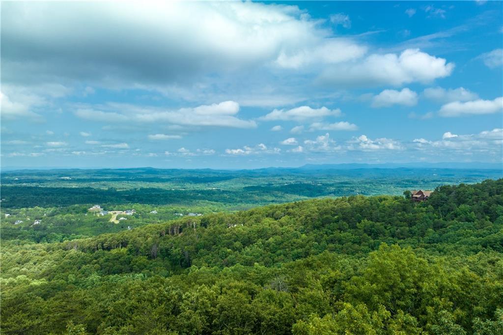 Incredible Opportunity in The Preserve at Sharp Mountain! This 16.85-acre tract is a rare find—encompassing an entire cul-de-sac and boasting over 1,000 feet of paved road frontage. These multiple lots were thoughtfully combined to allow for just one HOA fee, a feature no longer permitted in the community—making this property truly unique.
The land itself is breathtaking, with gently rolling, nearly level terrain, scattered with impressive rock outcroppings, natural boulders, and a canopy of mature hardwoods. The undergrowth is exceptionally clean, and Mountain Laurel is sprinkled throughout, adding to the natural beauty. From multiple vantage points, you'll enjoy long-range mountain views offering the perfect backdrop for your dream home or private retreat.
Whether you're looking to build a private estate or a family compound, the privacy, size, and topography of this property offer unmatched flexibility. There are additional adjoining lots available that could increase the total acreage to over 22 acres—ideal for even more seclusion or future expansion.
Located within the gated community of The Preserve at Sharp Mountain, you'll also enjoy access to multiple nature parks, scenic walking trails, pavilions, a community fireplace, and play areas. This serene mountain neighborhood is just minutes from Hwy 515, downtown Jasper, shopping, and Piedmont Mountainside Hospital.
This land must be seen in person to be truly appreciated—photos simply don’t do it justice!