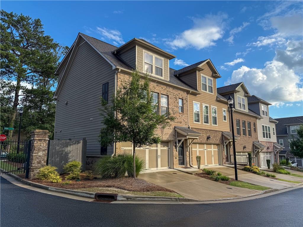 Welcome to 2452 Coosa Valley! This is a like-new townhome built by Taylor Morrison Homes in the perfect location. Easily access Truist Park, Midtown, Downtown, 1-75/I-285, and more. The main floor features an open-concept living area filled with abundant natural light, offering space for dining, and upgraded custom shades for added privacy. The stylish kitchen flows seamlessly into the living space, making it ideal for both entertaining and relaxing at home. Upstairs, the tranquil owner’s suite boasts a spacious walk-in closet, a spa-like en-suite bath with dual vanities, and a beautifully tiled walk-in shower. A large secondary bedroom with its own private bath provides comfort and privacy for guests or family. The terrace level includes a third bedroom with private access, a full bath, a laundry room with side-by-side washer and dryer, and access to the rear patio and peaceful green space—perfect for a roommate arrangement or private guest suite.
Set within an intimate community of just 32 homes, residents enjoy shared amenities such as a serene fire pit area, creating a welcoming neighborhood atmosphere. The home also features a front-entry garage and parking for two additional vehicles, blending convenience with luxury. Don’t miss your chance to own a beautifully appointed home in one of Atlanta’s most connected and desirable locations!