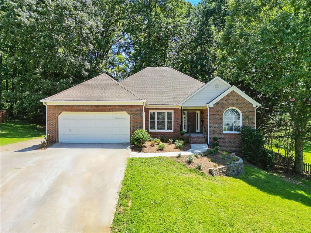 You’ll love this beautiful brick-front, updated ranch in a well-established swim community. As soon as you enter, the soaring two-story foyer bathed in natural light, designer paint and gorgeous refinished hardwood floors will catch your eye. Every detail of the home was thoughtfully renovated with a designer’s eye. The spaces all flow perfectly into each other making a modern open living space. That space is flanked by a study/office and a formal dining room. The kitchen is a showstopper with new cabinets, granite, custom backsplash and stainless-steel appliances. It opens to the living room with a beautiful gas starter fireplace. The breakfast area leads out to a large covered porch and a deck perfect for grilling. The wooded yard offers lots of privacy space to play. The blend of indoor and outdoor spaces is ideal for hosting large gatherings with family and friends. The vaulted ceilings throughout give it a wonderful bright open feel. The master bedroom with trey ceiling has a private bath with a brand-new double bowl vanity, large soaking tub and a separate shower. The two secondary bedrooms are nice sized and share a full bath with tub shower combo. Head downstairs to the finished basement with brand new mini-splits and you’ll quickly realize this home has so much more space than you expected. The massive family room has plenty of room for watching movies, playing ping pong and anything else you can imagine. The oversized bedroom has a full bath, walk-in closet and a kitchenette. Numerous other finished and unfinished areas give you endless options. This home is Move-in ready with fresh paint, new bathroom vanities, new plumbing and electrical fixtures, newer roof and HVAC system and so much more. You’ll be proud to call it home! This home has easy access to Dallas Hwy and Barrett Parkway. It’s close to shopping, dining, top rated schools and minutes to Avenues at West Cobb, Kennesaw Mountain and Marietta Square. Owner has not lived in the property so limited disclosures. As a nice bonus it has the benefit of low Cobb County taxes!