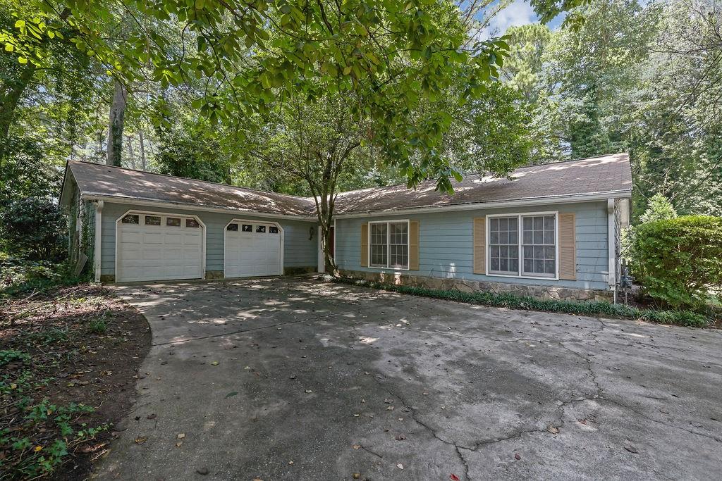 Welcome to this charming and spacious ranch-style home, full of potential and ready for your personal touch! This 3-bedroom, 2-bath home features a 4-year-old roof and a brand new refrigerator in the open, eat-in kitchen. The living room is warm and inviting with a gas fireplace and gas logs—perfect for cozy evenings. The primary suite offers two closets and an en-suite bath with a double vanity. Enjoy the privacy of a level backyard ideal for relaxing or entertaining. Additional highlights include a 2-car garage on the main level and ample storage throughout the home. A wonderful opportunity in a great