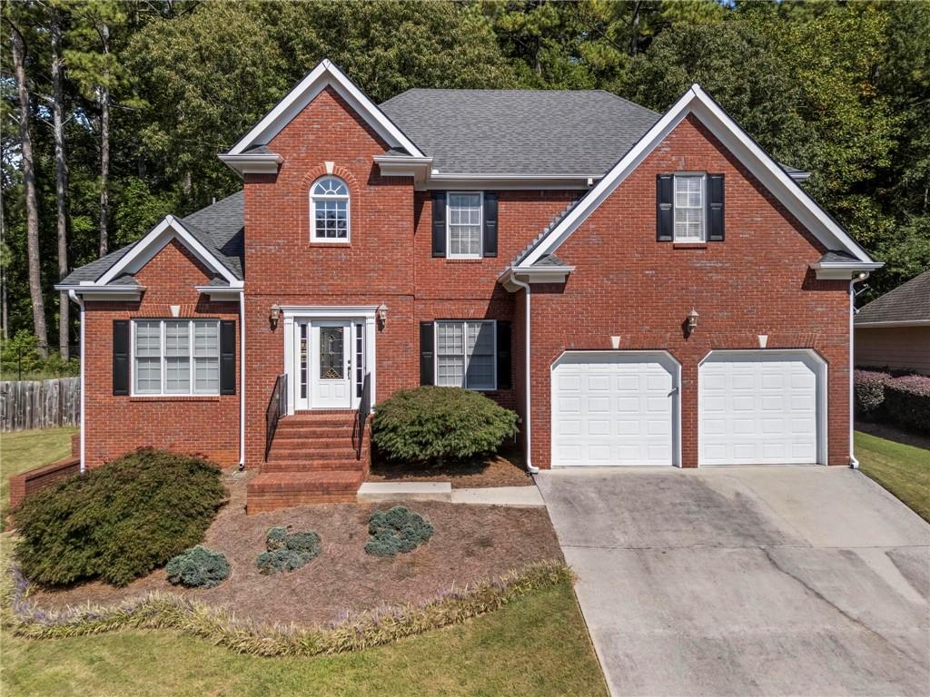 Welcome to a home where entertainment, comfort, and nature converge. Nestled on a cul-de-sac and directly backing up to over 3,000 acres of Kennesaw Mountain National Battlefield Park, this move-in-ready Marietta 5-bedroom/4-bathroom 3-sided brick executive home offers direct private access to scenic trails, abundant wildlife, and a fenced, level backyard with raised garden beds. Outdoor living shines here with an XL screened-in porch and a large deck with built-in seating. The true star of this home is the incredible soundproof theater room—a professionally designed space that rivals a real cinema. Outfitted with tiered leather recliners, dimmable theater lighting, and wall sconces, a full electronics package, a gaming system, a wet bar with a mini-fridge, and even a popcorn machine, it’s ready for movie nights and game days. The terrace level also features a private entry with its own patio, spacious family/game room, full bath, generous storage, and a finished bonus room—ideal as a guest space, home gym, or office. A main-level guest suite with a full bath provides the perfect option for in-laws, visiting family, or can be used as a home office. The heart of the home, the light-filled kitchen, was built larger than the original floor plan and includes an oversized walk-in pantry, abundant cabinetry, a center island, and an open flow and view to the great room with access to the roomy screened porch. The main floor features a grand two-story foyer with marble floors, a formal living room, a separate dining room, a great room with a fireplace, and a guest/in-law suite. Upstairs, the luxurious primary suite includes a cozy fireplace, master bath, and huge walk-in closet. A secondary bedroom offers a private sitting area and computer room, and features a Jack-and-Jill bath with an additional bedroom #3. With the flexible spaces throughout, this home is designed for multigenerational living and entertaining. With timeless design and unmatched access to nature, 1703 Rifle Ridge offers a rare lifestyle. Located in the Hillgrove HS award-winning school district and conveniently located to Kennesaw Mountain, hiking trails, historical monuments, KSU, Truist Park, Kennestone Hospital, dining, shopping, major highways, and more.
