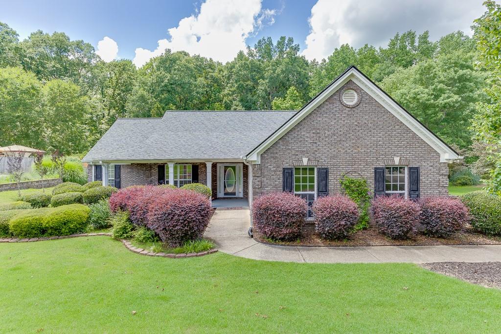 Welcome to this elegant 4-sided brick ranch, set on a tranquil and private lot of over half an acre. Featuring three bedrooms and two bathrooms, the home delivers a well-balanced layout with durable construction and minimal exterior maintenance. Enjoy abundant natural light in the bright sunroom—perfect for morning coffee, plants, or additional lounge space. The enclosed patio expands your living area, offering a comfortable space for socializing or relaxing throughout the year, with seamless access between indoors and outdoors. Inside, discover a practical layout where the primary bedroom includes an adjacent full bath and generous closet space. Two additional bedrooms share a well-appointed secondary bathroom. The living room flows into a dining area and an efficient, well-equipped kitchen. The expansive backyard provides plenty of room for gardening, recreation, or future customization—while the lush surroundings offer a peaceful and private retreat.