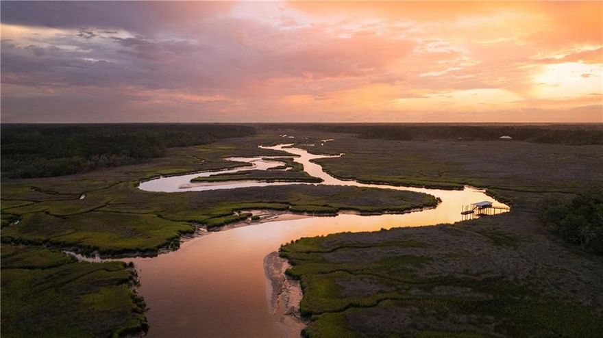 One of the most extraordinary coastal properties in the Southeastern United States, Hampton Island Preserve spans approximately 4,000+/- acres of maritime forest, salt marsh, and historic terrain. This offering presents 2,099 of its most pristine and developable acres, encompassing a remarkable blend of natural beauty, rich Southern heritage, and world-class amenities, all just 35 minutes south of Savannah, Georgia. Connected to the mainland by a single-lane bridge and accessible by car, boat, seaplane, or helicopter, this private enclave offers a rare combination of seclusion and accessibility. Surrounded by more than 12 miles of tidal salt marshes, riverfront, and scenic waterways, the property is a haven for those seeking an immersive connection to land, water, and sky. The offering includes: A Signature Davis Love III Golf Course (Ricefields), gracefully weaving through 200-year-old rice fields and freshwater lakes; several guest cottages, each offering refined interiors and architectural integrity that embrace Lowcountry heritage; an award-winning equestrian center, featuring a 6,612+/- square-foot reclaimed wood barn with 12 stalls, signature black fencing, paddocks, a climate-controlled tack room, and Equistall flooring designed for equine wellness; two distinct spas, including the treetop-inspired Treehouse Spa with 360-degree nature views, and the Herbal Treatment Spa set within the island’s 16+/- acre organic farm; Harvest Lake Farm, a working organic farm with a two-story barn and educational center, all crafted from reclaimed materials; a potential marina site with existing dock infrastructure, boat hoist, and floating dock; miles of trails for horseback riding, walking, and exploration across a landscape of preserved maritime forest, open pastures, fish-stocked ponds, and deep water frontage, accessible by dock or golf cart. Hampton Island’s storied past spans Native American heritage, and once home to the King family and later revived by visionary developers, the property stands as a testament to the balance between preservation and possibility. With its existing infrastructure, breathtaking scenery, and unmatched potential for resort development, private estate creation, or conservation-minded investment, Hampton Island Preserve presents a once-in-a-lifetime opportunity to reimagine the next chapter of a truly iconic property.