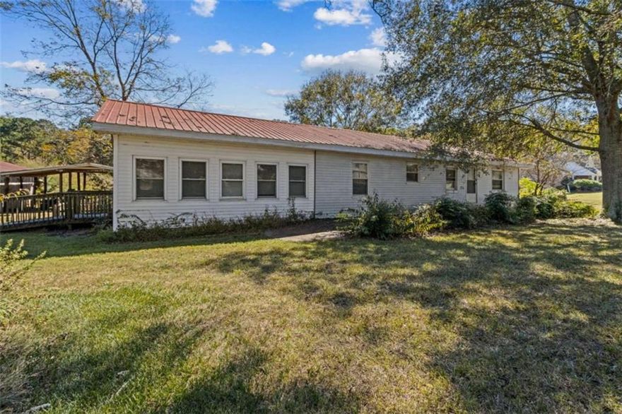Cash Only-Will Not Qualify for Financing.  Super rare opportunity to own beautiful acreage in the sought-after Appalachee School District! This peaceful property features a simple homeplace nestled beneath gorgeous shade trees-ready for a total renovation to make it your own or the perfect site to rebuild your dream home. The existing structure offers potential for 4 bedrooms and 2 full baths with handicap ramp access. Enjoy quiet evenings on the back porch overlooking the serene property. Outside, you'll find a large carport, 2-bay shop, spacious pole barn, rustic barn, and open pasture. With approximately 313 feet of road frontage, the possibilities here are endless!