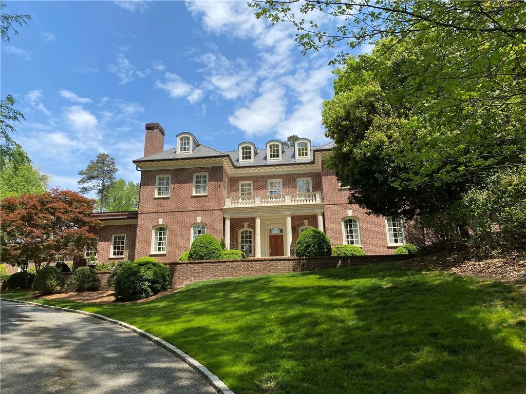 Traditional styled home designed and built in a collaborative effort by Bill Baker and Jerry Hicks Builders. This exquisite house has a grand entry with marble floors and offers privacy on 2.15 acres in a quiet cul de sac in Buckhead. The lot backs up to a protected land preserve. Primary suite is ideal on the main level with separate office space attached. There are 5 bedrooms and 5 bathrooms upstairs including a bedroom/bath over the 3 car garage with separate access. The main level includes a formal living room as well as a spacious kitchen with breakfast area. Throughout the house are 11.5ft ceilings, hardwood floors, and 4 fireplaces with one additional outside fireplace next to the pool. Spacious sunroom located next to family room with walk out access to a professionally landscaped private backyard with a large flat grassy courtyard perfect for kids to play or lounge by the in ground pool. Sit under the pool cabana and enjoy the view. This outdoor living area is ideal for entertaining. Full basement with gym and second living room with additional wet bar, half unfinished for storage or workshop space.