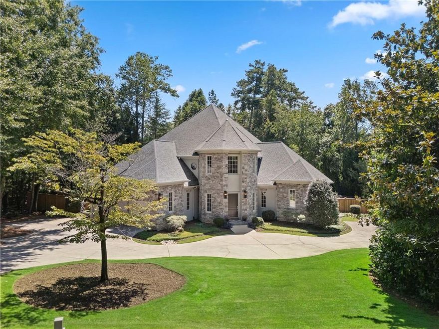 A True Legacy Estate on 1 Private Acre with Resort-Style Pool in the heart of North Buckhead! Some properties simply can’t be replicated—and this is one of them. A true unicorn estate, this home has been cherished, transformed, and carefully maintained as a legacy property, with every surface touched, every system replaced, and every detail restored or reimagined. While the home now lives like new construction, its setting and soul are irreplaceable.
*THE VALUES YOU CAN MEASURE INCLUDE* - Replacement Cost: To recreate this home today would approach $4 million+, not including its priceless mature landscaping & lot. Pool & Outdoor Living: The custom pool, spa, stonework, and double waterfall represent an investment of over $400K+ alone in today's market. Brand New Upgrades: New roof, four high-efficiency HVAC systems, all-new lighting and plumbing fixtures, refinished hardwoods, fresh interior/exterior paint, and a whole-home generator. *THE VALUES YOU CANNOT BUY* - For more than 25 years, the owners have cultivated soaring trees, lush greenery, and a landscape that creates both privacy and serenity—something no builder or budget can fast-track. This natural maturity wraps the property in a sense of permanence and peace, setting it apart from anything else on the market. *THE HOME* - Set on a quiet cul-de-sac with a park setting, the estate opens with a dramatic two-story circular foyer, coffered ceilings, and an architectural staircase that immediately convey craftsmanship. The flow is designed for both living and entertaining, with a formal living/music room, elegant dining room, and a two-story great room filled with light. The designer kitchen anchors the home, featuring a large center island, abundant workspace, and casual dining, all open to the 2-story great room for seamless gatherings. The primary suite is a true retreat: complete with its own fireplace, oversized walk-in closet, luxurious spa bath, and easy access to the deck & pool terrace. Upstairs are three spacious bedrooms and two full baths, while the finished terrace level offers a media room, guest suite, and tons of space for future expansion. *THE GROUNDS* - Arrive through the extra-wide circular driveway with multiple parking pads, with an extension to a 3-car side-entry garage that ensures plenty of space for family, guests, and entertaining. The backyard is a private resort: a brand-new deck, custom stone pool with 2 upper waterfalls and 3rd infinity waterfall spilling 10+ feet into a gorgeous stone pond, a heated spa, spacious sunny lawn area, natural area, and space for a future sports court. Every inch of the acre is usable, private, and beautifully framed by decades of thoughtful landscaping. This is more than a home—it’s a legacy. A unicorn property that combines the credibility of meticulous renovation with the intangible value of time, care, and setting.