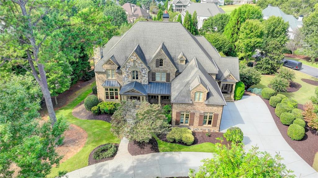 Beautiful craftsmanship and light-filled spaces makes this one of the prettiest homes to come to market in prestigious Sugarloaf Country Club.  Great location, closed to I-85.  Builder's Home, great location across from playground and sport center.  Hardwood floors throughout entire house.  Prewire for speakers, amazing chef's kitchen with Wolf range(6 burner), Subzero refrigerator, Bosch dishwasher, pot filler, huge wide walk in pantry with wine cooler.  Two story foyer and Grand room.  Keeping room with stone fireplace.  Covered verandah with stone floor.  Back foyer includes office, powder room, laundry room with sink.  Grilling deck off breakfast room.  Central Vacuum.  Plantation shutters throughout.  Spray Foam Attic Insulation for energy savings. Epoxy garage floor.  Sugarloaf Residential POA is $2947 per year and covers security gates, security guards, common area maintenance, reserve fund and price road maintenance.  Sugarloaf Country Club amenities are available for a separate membership.  Home of the TPC at Sugarloaf golf course, host of the Mitsubishi Electric PGA Champions Tour Event.