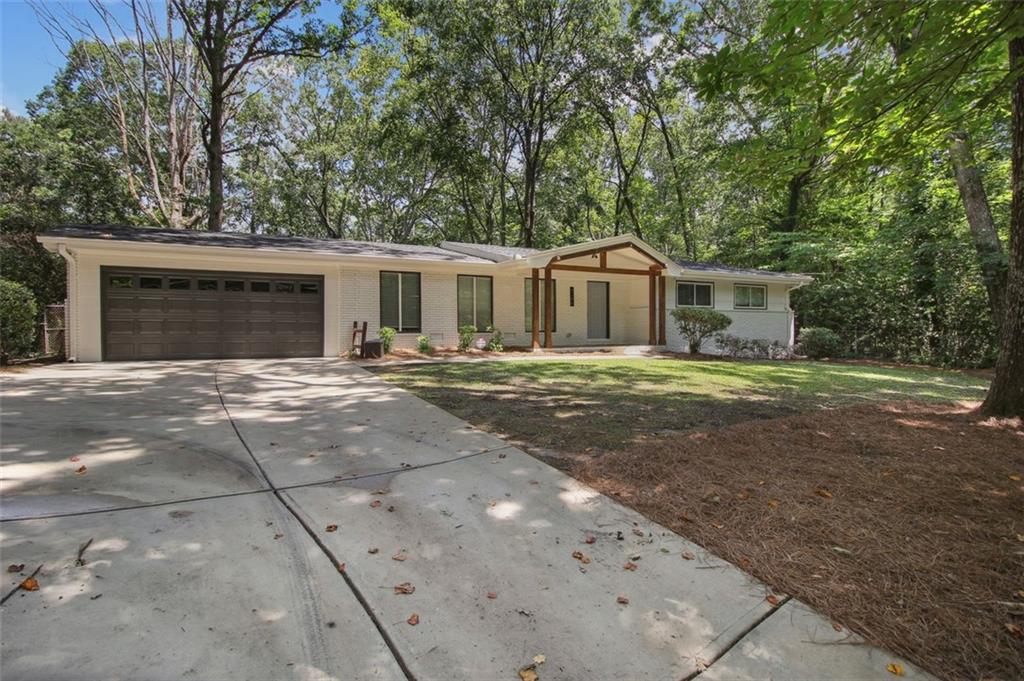 Welcome to this stunning fully renovated 3-bedroom brick ranch-style house on a private half acre lot. As you approach the house, you'll be welcomed by a spacious slate tile front porch. Step inside to see beautiful hardwood flooring that flows seamlessly throughout the entire home, creating a warm and inviting atmosphere.
The home was extensively updated in 2018 from top to bottom including the addition of new double paned windows and entirely new systems. A new roof was installed this summer.
The heart of this home is the updated kitchen, showcasing shaker style cabinetry, top-of-the-line stainless steel appliances including a gas range and microwave drawer, ensuring a chef's dream cooking experience. You'll love the sleek granite counters and the stylish tile backsplash, providing the perfect balance of practicality and aesthetics.
One of the highlights of this property is the kitchen and dining area’s view, overlooking a private and spacious half-acre lot.
The master bedroom is generously proportioned, featuring a double vanity, a large tiled stand-up shower.
Modern touches throughout the home like a shiplap accent wall and cedar beams help to elevate the overall design.
In addition to its interior charm, this home offers a two-car garage, providing ample space for your vehicles and storage needs.
As for the location, this home is centrally located and offers easy access to major points of interest, such as Emory University, Children's Hospital, CDC, I-85, and I-285. Despite its convenient proximity to these amenities, the property still maintains a serene and peaceful atmosphere, perfect for unwinding after a long day.