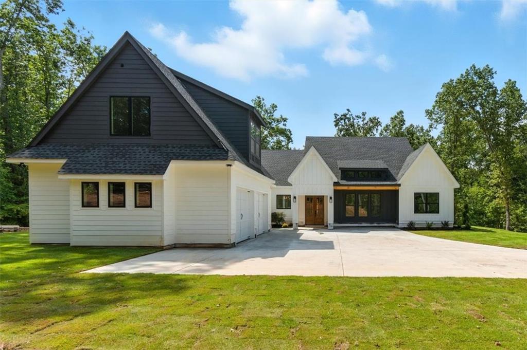 Welcome to this stunning new construction Modern Farmhouse nestled on 3 private acres in Canton, just off Hwy 20. Designed for both comfort and style, this ranch-style home offers 5 spacious bedrooms, 4.5 baths, and an open floor plan perfect for entertaining. The heart of the home features a gourmet kitchen, seamlessly flowing into the living and dining areas, creating the ideal space for gatherings. Step outside to your expansive outdoor living area, perfect for relaxing or hosting guests in your serene, private oasis. This home is truly made for entertaining, with thoughtful touches like a walk in pantry, a convenient laundry room connected to the owner’s suite, and a bonus room above the garage that’s perfect for a home office, playroom, or extra guest space. Located on a quiet street, you'll enjoy peace and privacy while still being close to everything – top-rated schools, shopping, and Veteran's Park are just minutes away. Don't miss the chance to make this beautifully crafted farmhouse your forever home!