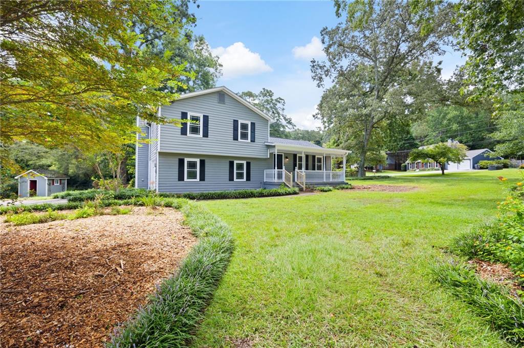 Don’t miss this rare opportunity to own this recently renovated, move-in-ready property in Marietta! This home offers 3 bedrooms, 2 bathrooms with new carpet, new paint (both interior and exterior), new gutters, and new exterior doors. In addition, there is also a newer roof (2024), heating & air (2018), kitchen cabinets (2024), and windows. Enjoy the view of this almost half acre corner lot from your rocking chair front porch. The basement den is a cozy place to relax by the stone fireplace. The kitchen boasts newer appliances, stone countertops, and tile backsplash. The bathrooms offer updated vanities, lighting, and plumbing fixtures. The backyard boasts a stone patio, fire pit, and storage shed. Conveniently located near great restaurants and shopping at Towne Center, Marietta Square, and the Avenue West Cobb. In addition, there is easy access to I-75 on Barrett Parkway.