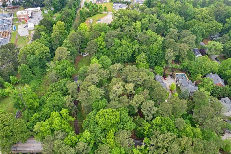 Rare Opportunity in Morris Brandon School District – Don't miss your chance to build your dream home on nearly a full acre in the highly sought-after Morris Brandon school district! Tucked away in a serene, wooded setting, this level homesite offers the perfect blend of privacy and possibility. With water and sewer already in place, this lot is ready for your custom vision—whether it’s a luxurious estate or a private retreat nestled among the trees. Opportunities like this are few and far between in this prestigious area. Homesites of this size and location rarely become available. Let’s make your dream home a reality. A survey is available upon request. The adjoining lot with the home is being sold seperately or they can be sold together.