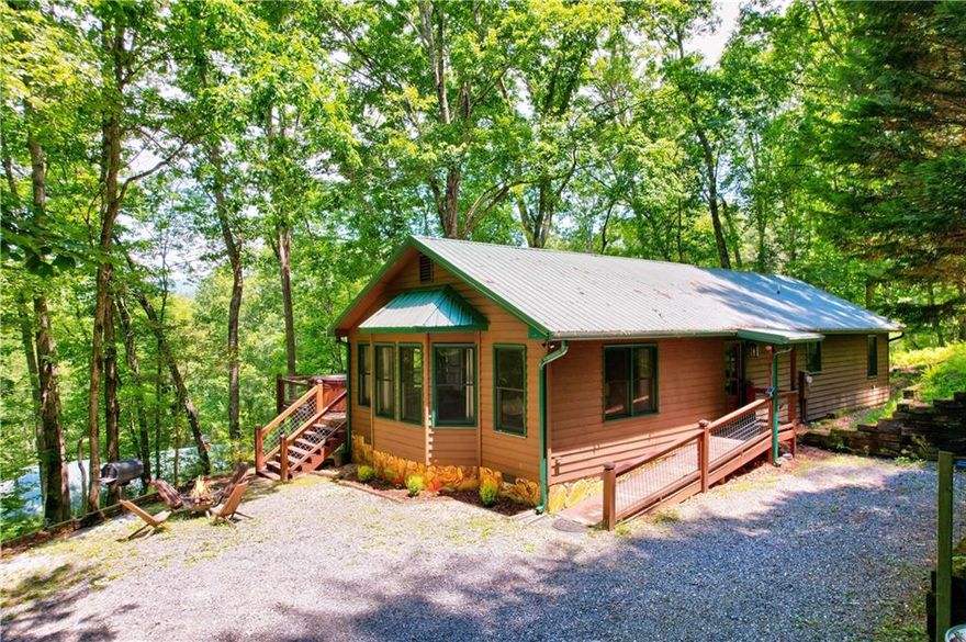 Beautiful Blue Ridge Cabin with modern rustic luxury. This single story exquisite cabin is sold fully furnished and is perfect for short term rental, 2nd or primary home. The cabin is off one of the most scenic roads (Aska) and located 1 mile from the Toccoa River. Enjoy the long range views and nature that surrounds you from your extensive porch areas. The entire cabin was updated in 2021 which includes; NEW metal roof, WH, deck, appliances, light fixtures, wall staining & more. NEW Hot tub & HVAC in 2023. This open concept floor plan cabin includes volume ceilings & large windows for natural light. A combination of custom woodwork & drywall brings warmth and elegance throughout. The inviting living room area offers a stone gas fireplace and a perfect setting to relax or socialize. The kitchen includes ample cooking/storage space as well as an island with an eat- in area. Beautiful cabinetry, quartz counter tops, glass inlay tile to the ceiling, modern light fixtures & premium stainless steel appliances are just some of the many features of this kitchen. Your dining area accommodates a large group for dining or just enjoying the area for star gazing or table games. The primary bedroom is a dream… Large windows, sitting area, king size bedroom furniture set & a bathroom suite that will surely impress you! The bathroom has dual sinks, walk-in shower with custom tile work and more! The 2nd and 3rd bedrooms are on the other side of the home for additional privacy. The 2nd bathroom is modern and includes a top mount sink, tub with glass doors and custom tile work with niche. Private setting, fire pit and beautiful decks are perfect for relaxing and enjoying your evenings. Enjoy viewing abundant wildlife and beautiful sunrises/sunsets. Fishing, tubing and trails nearby. The beauty, detail and elegance in this cabin is a rare find for this price! Schedule a showing today!