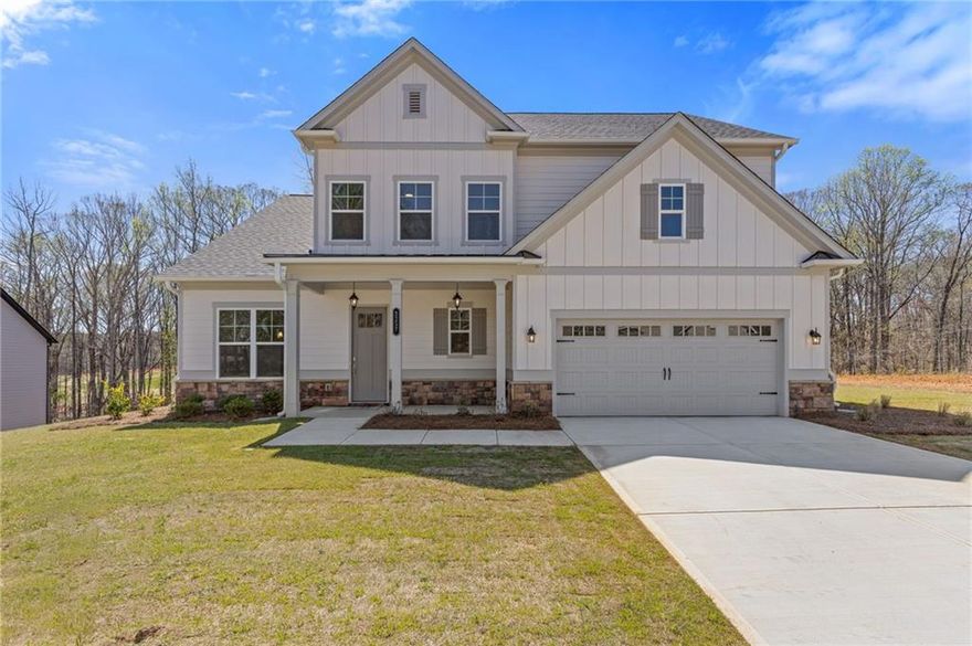 Welcome to your dream home at 3257 Traditions Way, a beautifully crafted Jamestown plan nestled in the prestigious Traditions of Braselton community by Paran Homes. This exquisite new construction offers five spacious bedrooms and four full baths within a thoughtfully designed open-concept layout that blends timeless elegance with modern comfort. The heart of the home features a chef-inspired kitchen with granite countertops, stainless steel appliances, a large center island, and a walk-in pantry—perfectly positioned to overlook the fireside family room and sunlit dining area. A main-level bedroom and full bath provide flexible space for guests or a private office. Upstairs, retreat to the luxurious primary suite complete with a sitting area, expansive walk-in closet, and spa-like bath with dual vanities, a soaking tub, and a stunning mega shower. Enjoy outdoor living on the covered patio overlooking a serene backyard. Residents of Traditions of Braselton enjoy resort-style amenities including an Olympic-sized pool with water slide, fitness center, clubhouse, tennis and pickleball courts, walking trails, and an 18-hole golf course, all set within a vibrant and beautifully maintained master-planned community. This is a new construction home. Photos and finishes are representative and may not reflect the actual home.