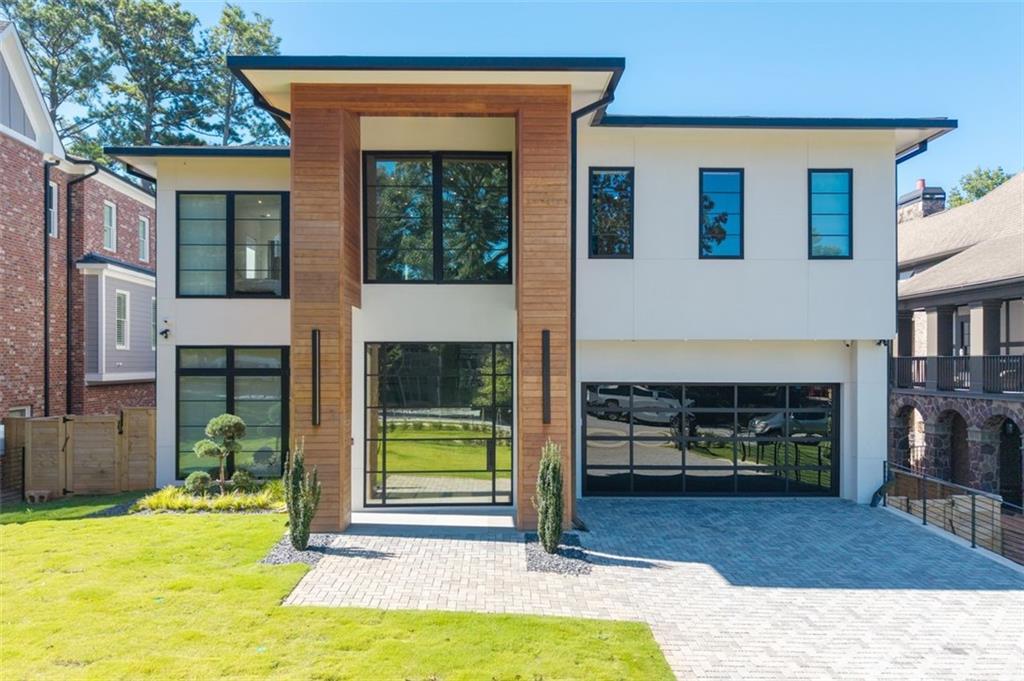 Experience the pinnacle of modern luxury in this I & G Builders architectural masterpiece featuring 5 bedrooms and 5.5 baths. Walls of glass invite in an abundance of natural light, seamlessly blending indoor and outdoor living while showcasing clean lines and refined design. The chef’s kitchen boasts custom cabinetry, professional-grade appliances, and an oversized leathered soapstone island crafted for both function and style. Expansive living and dining spaces flow effortlessly, perfect for grand entertaining or intimate gatherings. Each bedroom offers a private en-suite retreat, with the primary suite serving as a sanctuary complete with a spa-inspired bath and boutique-style dressing room. Outside, a resort-caliber pool is framed by sleek terraces and lush landscaping, creating an idyllic setting for relaxation. Every detail of this residence exudes sophistication, offering a lifestyle defined by elegance, comfort, and distinction.