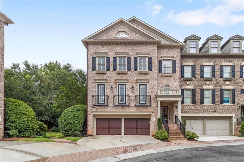 Luxury End-Unit Townhome with an Elevator in a beautiful gated community. This 4-level townhome wouldn't be complete without your own personal elevator. The amenities don't stop there, the original owner added over 100k in upgrades and bonuses that other homes in the neighborhood do not have. One of those luxury features is the subzero fridge, which seamlessly blends in with the cabinets and the other high-end appliances throughout the kitchen. The living area features an open-concept to the kitchen and offers direct access to the beautiful and one of the largest back patios in the neighborhood. Living room features custom built-ins and a stunning stone fireplace mantle. Other features like a large dining room, a gorgeous half bathroom for guests and a convenient built-in office off the living area. The main bedroom features an oversized soaking tub, steam shower and double sinks with plenty of extra storage. The large guest suite is equipped with its own ensuite bathroom and large walk-in closet, plus the laundry is conveniently located in the hallway off the main bedroom. The lower-level features a massive bedroom with custom built-ins. The terrace level offers a bonus living space equipped with a wet bar and wine fridge. Perfect to use as a game room, media area, or even an extra bedroom. This expansive 4th level provides extra space for guests or entertaining with direct access to the balcony with seasonal skyline views of Buckhead and Midtown. Updated flooring in all levels and no carpet throughout the home. High-end fans and fixtures. Residents of One Ivy Walk enjoy resort-style amenities including a beautiful pool with fountains, fitness center, and clubhouse. The home offers easy access to the shops and restaurants within One Ivy Walk—just steps away from your front door, like the famous Muss & Turner's and more. This is a great opportunity to own one of the most luxuries townhomes in the highly desirable Vinings location—easy access to I-285, West Village, Smyrna Marketplace, The Battery and the best of city living.