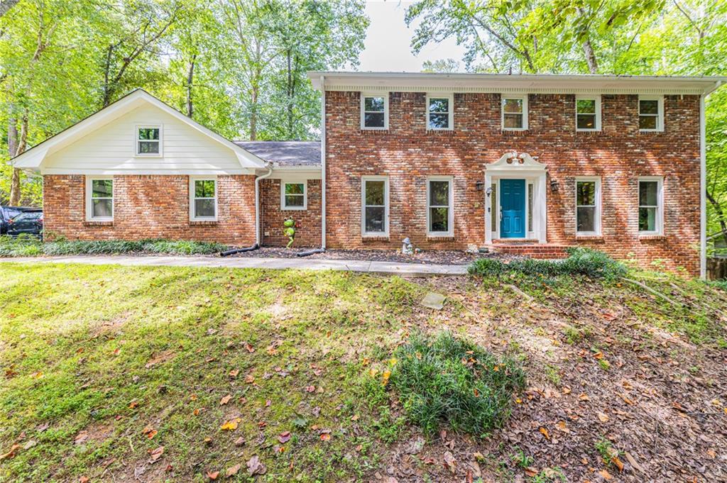 Preferred lender offering rates as low as 4.99%. Charming 4-Bedroom Brick Front Traditional on Cul-de-Sac in Sought-After Swim/Tennis Community! Welcome to this beautifully updated 2-story traditional home, nestled on a quiet cul-de-sac in a vibrant swim/tennis community featuring a scenic lake, near walking trails, and easy access to top amenities. With 4 spacious bedrooms, 2.5 baths, and a finished basement, this home offers comfort, style, and space for every lifestyle. Step inside to find gleaming hardwood floors on the main level, fresh interior paint throughout, and renovated bathrooms that combine modern finishes with timeless design. The inviting living room features built-in bookcases, perfect for displaying your favorite reads or decor. The bright kitchen boasts stainless steel appliances, generous cabinet space, and flows into the breakfast area. Upstairs, enjoy brand new carpet and four generously sized bedrooms, including a serene owner’s suite with a beautifully updated ensuite bath. The finished basement offers flexible spaces ideal for a home gym, office, playroom, or media space with plenty of extra storage to keep things organized. Relax or entertain on the large deck or enjoy a quiet morning in the screened porch overlooking the private backyard. Additional recent upgrades include: New siding, New windows, New HVAC system. Whole house water filtration system! Located just minutes from shopping, dining, entertainment, parks, and top-rated schools, with quick access to I-75, I-285, and GA-400, this home offers both convenience and lifestyle. Don’t miss this move-in ready gem in a community that has it all!