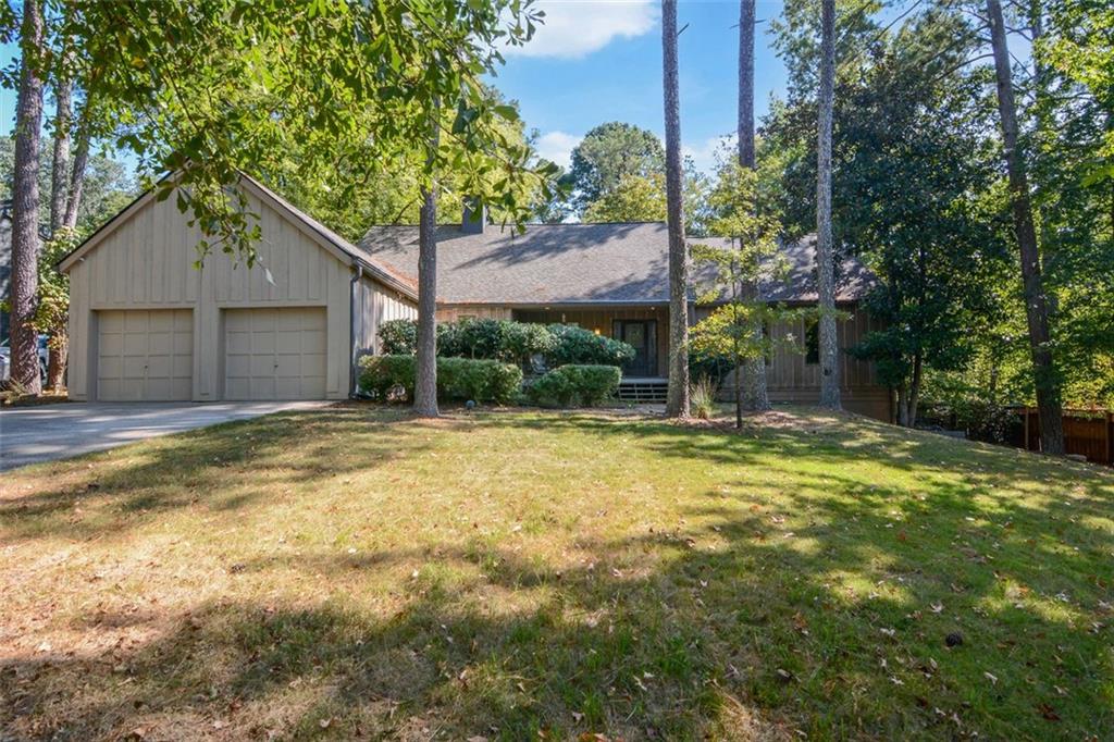 INVESTORS DREAM! Come see this incredible opportunity for a home that has amazing potential. The owner has started some DIY projects and they are ready for you to finish. The beams in this home are from an old barn. Take the spiral staircase up to a private loft. Expand the kitchen into the dining room to create a beautiful kitchen and add a deck to a lot that is just over 1/2 acre right in Peachtree Corners. A double third bedroom can be made back into two bedrooms to make this a four bedroom home, with the primary bedroom on the main. The focal point of this home is the spacious family room with a large fireplace, vaulted ceiling and the beams from the old barn. A new roof installed in 2023 takes away a large expense! Full basement with another garage and garage door. A large Tuff Shed in the backyard with a 10ft custom height ceiling is perfect for a workshop, storage or hang out space. Located on a non-busy cul de sac street, this home is waiting for a renovation top to bottom with endless possibilities. ESTATE SALE COMING SOON!