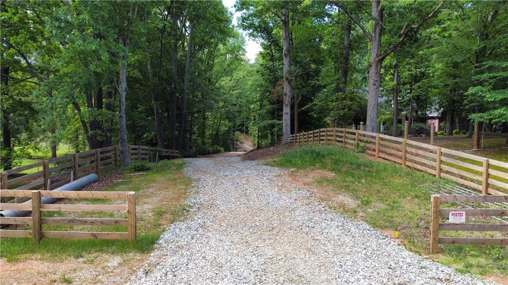 A Rare Opportunity to Own Over 10 Acres in Prime Forsyth County
Discover the perfect blend of privacy, convenience, and natural beauty on this stunning 10+ acre tract, nestled among mature hardwoods with a meandering creek running through the property. A gravel road has already been cut in, and utilities are available—making this land ready for your vision. All lots have passed perc testing and are suitable for building.
Whether you're dreaming of a custom estate, a small family compound, or a peaceful weekend retreat, this property offers unmatched flexibility. The land is zoned Agricultural—Forsyth County’s most versatile zoning—allowing a wide range of uses while preserving your privacy and space.
An added bonus: the owner is a respected high-end custom builder, offering a build-to-suit option to help bring your dream home to life with impeccable craftsmanship.
Enjoy ATV riding trails, tranquil creek views, and the feeling of a mountain escape—without the long drive. Conveniently located just minutes from top-rated Forsyth County schools, shopping, dining, and Hwy 400.
This is your chance to own a slice of nature with the convenience of modern living. Feel like you are in Big Canoe—but without the commute