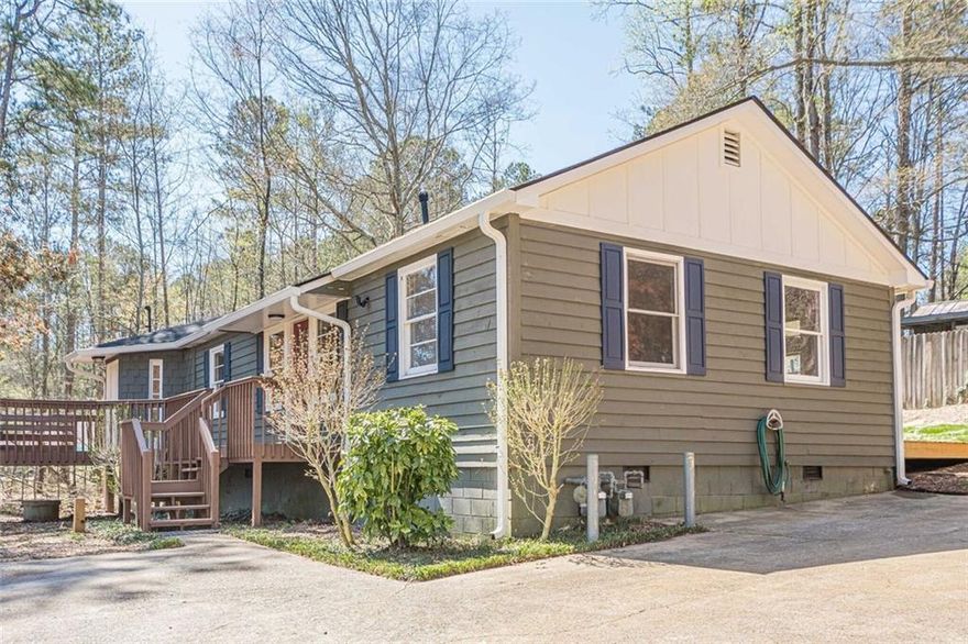 Welcome home to this charming ranch on S Holly Springs Road and NO HOA!  You'll instantly feel at ease in this 3-bed, 2-full bath haven tucked away on a large, private .6 acre lot. Inside, the fresh finishes and flowing floorplan invite relaxed living.- from new flooring underfoot to the kitchen made for gathering and everyday life. Step outside and you'll find the extra bonus: a large open deck wth skylights to add extra entertaining space or just relaxing space under the treetops.
A large detached 850 sq. ft. structure behind the main house, offers endless possibilities-convert it into a workshop, studio, guesthouse or income space. Conveniently located minutes from Downtown Woodstock, shopping and dining, this home combines comfort, flexibility and convenience in on exceptional package.

Please call for more info. 
Kathryn DeSantis  770-375-7725
