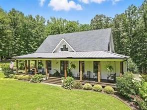 Welcome to your dream estate! Selling with 2 HOMES ON THE PROPERTY AND TOTAL OF 7.68 ACRES! Perfectly positioned in one of Cherokee County’s most desirable locations and zoned for the award-winning Creekview High School, this 2017 custom-built farmhouse is a rare find. Just minutes to Milton, Alpharetta, and Ball Ground.
Main home is Sitting on 5.48 acres of pristine, landscaped land, this 4-bedroom, 3-bathroom estate is a peaceful retreat with modern amenities, timeless charm, and flexible living space that fits your lifestyle today—and grows with you tomorrow.
This home features a thoughtfully designed open-concept layout with expansive great room, sunroom, and bonus room, inviting spaces with vintage distressed hardwood floors throughout the main level. First-floor owner’s suite featuring a spa-like bath, walk-in shower, custom vanity, and spacious walk-in closet, Gourmet kitchen with stone countertops, high-end appliances, and ample cabinetry—perfect for the home chef! Seamless flow between the living, dining, and kitchen areas. Beautiful sunroom off the kitchen with a wood burning fireplace. This home is ideal for gatherings and entertaining!
Upstairs Living & Flex Space:
This unique home offers two separate upstairs entrances for maximum versatility: there is a Private suite above the garage—ideal for guests, a home office, or playroom and a Second staircase leads to two oversized bedrooms, a full bath, and a bonus room perfect for a game room or additional office space!
Downstairs there is 2,000+ sq ft partially finished basement with endless possibilities: in-law suite, gym, theater, bar/kitchen—a blank canvas for your vision!
Some additional features of the property include Control4 smart home system with integrated Sonos speakers throughout, Irrigation system in front and side yards for easy maintenance and a 2 stall barn!
This property is a true gem and has its own peace with this outdoor oasis, wrap-around porch for morning coffee, evening wine, and everyday relaxing.
The second home is brick farmhouse-style home with 3 bedrooms and 2 bath on the property! Perfect for multi-generational living. This home features its own 2.2 acre lot with garden area and fenced back yard.
Note: This second home will not be shown without proof of funds or pre-approval for both properties.
Location Highlights:
• Minutes to top-rated schools, shopping, dining, and major highways
• Ideal for those seeking space, privacy, and convenience in one incredible package!
Don’t Miss This Rare Opportunity!
Whether you’re looking for your forever home, a multi-generational property, or a peaceful luxury escape close to it all, this stunning farmhouse offers more than just a home—it’s a lifestyle