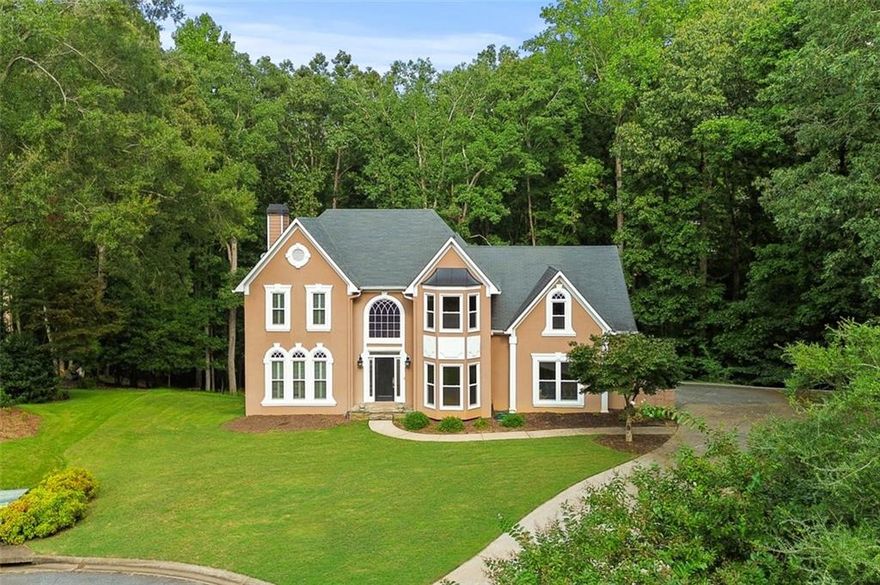 Beautiful home on a private, wooded, 3/4 acre cul-de-sac lot just a stone's throw from Lake Allatoona in sought after Eagle Watch. Must see! Renovated kitchen and baths. Hardwoods throughout. Finished basement with full bath and kitchen creates a fantastic in-law or teen space. Large windows provide ample light. Large separate dining room and great room are wonderful for entertaining. Just a short walk to the park, pool and tennis courts. Don't miss this incredible home.