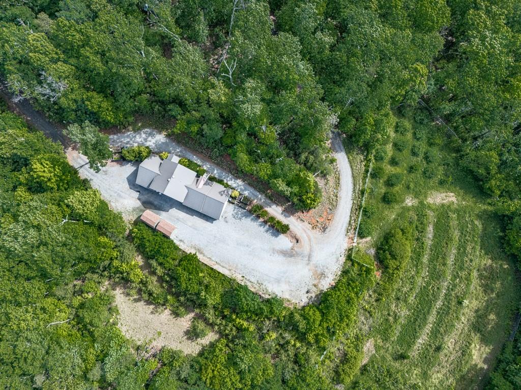 118 ACRE ESTATE with LONG RANGE Mountain Views! Perfect future family compound, hunting lodge and more!!! The main house is divided into two separate levels with separate entrances to each floor. The upper floor features an open concept kitchen and great room, 3 bedrooms and 2 baths and a large bonus room where stairs to the lower level could be reinstalled. The lower level of the home has multiple roll up doors for parking vehicles. A large kitchen with some commercial items to remain with home, adjacent to a mens and women's restroom, complete with shower stalls. There are two 16 x 12 outbuildings providing additional storage. There is a fenced in garden area with fruit trees and its own irrigation. There is a spring on the property to the South accessible at lower gate. Shown by appointment only.