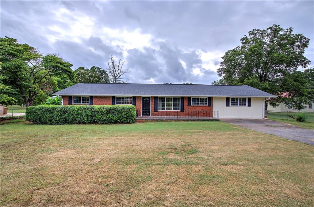 In search of a stepless ranch in Cartersville? This lovely home may be just what you’re looking for. Available now is this four sided brick ranch with a split bedroom plan that includes 4 bedrooms and 2 full baths. As you come in the front door you enter the large Great room with enough space to include a dining area if needed, as well as, access to the back patio and fenced backyard. To the left of the Great room are 3 bedrooms with hardwood floors, ceiling fans and good size closets. The hall bath has a tub/shower combination; a vanity with NEW granite countertops, lighting, mirror, and flooring. On the opposite side of the house is the BRAND NEW KITCHEN with ALL NEW CABINETS and granite countertops. There is a ton of pantry space and a breakfast area. The kitchen also has NEW flooring and oven. A large primary suite is located just beyond the kitchen with two closets and a full bath. The bath has a tub/shower and a new vanity. This fantastic home has great square footage, a level fenced yard and is in the Cartersville city limits. Don’t miss out on this great buy.