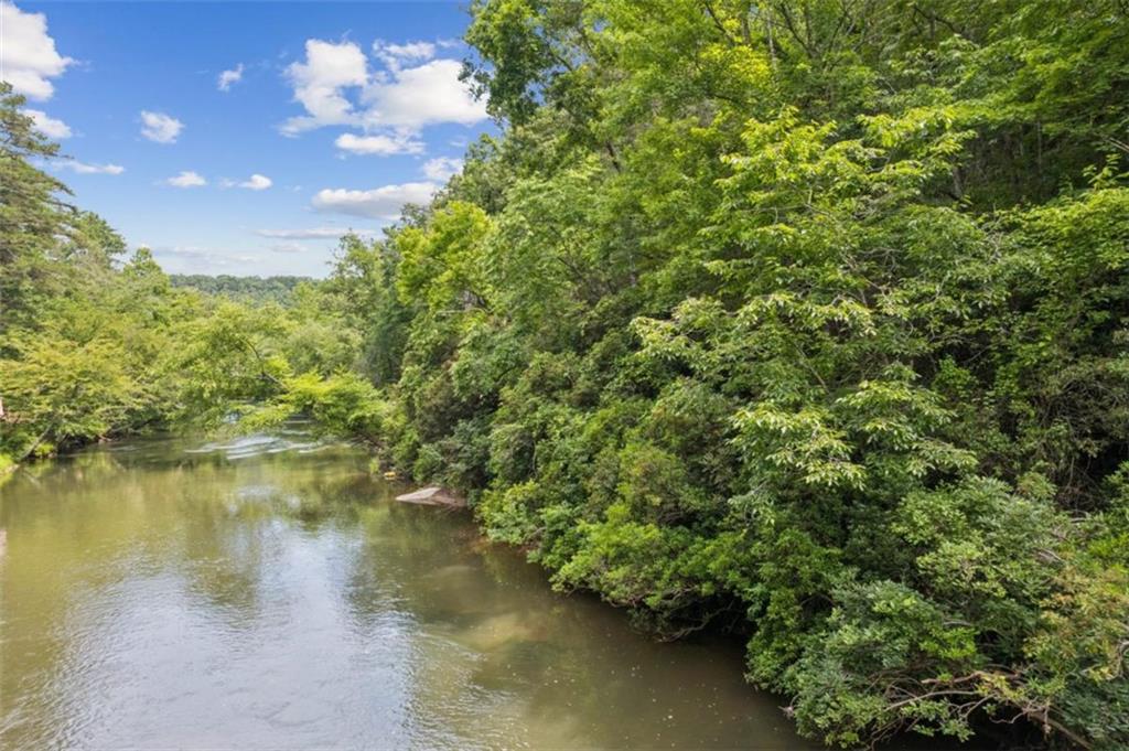 Prime RIVERFRONT Lot on the Cartecay! With 111 feet of direct frontage and boundaries extending to the river's center, this property offers no HOA fees and no rental restrictions, making it ideal for income potential or personal use. The lot’s topography is perfect for a walk-out basement design, offering both functionality and added value. Enjoy tubing, fishing, and kayaking right from your backyard. High-speed internet, city water availability, and paved access enhance convenience and livability. All this, just under 10 minutes from Downtown Ellijay! Adjoining Lots #3 (.88 acre), #4 (.66 acre), and #6 (.89 acre) are also available - expand your portfolio or secure additional privacy!