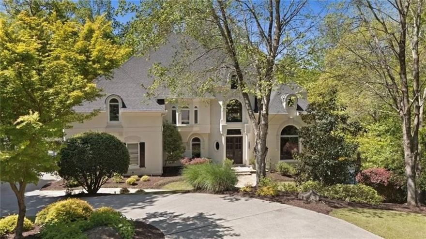 A One-of-a-Kind LAKEFRONT RETREAT,  
960 Tiverton Lane in Johns Creek is
Country Club of the South’s best-kept secret!!  Who knew serenity could look this good? Tucked away on what may be the most coveted lake lot and cul-de-sac setting in prestigious Country Club of the South, 960 Tiverton Lane is the hidden gem you've been waiting for. This custom estate artfully blends privacy, elegance, and modern upgrades—all perched above a tranquil lake, surrounded by lush trees and nature’s soundtrack.

Step inside to discover luxury at every turn, from designer lighting and custom window treatments throughout to an elegantly designed open-concept main level that invites you to gather, unwind, and soak in the view. The chef’s kitchen is beautifully appointed with a new Wolf cooktop with automatic downdraft, SubZero refrigerator and flows seamlessly into the family room and casual dining area—all walking out to a scenic deck that feels like your own private treehouse.

On the main level, the primary suite is a total transformation—featuring sweeping views of the tranquil setting. The thoughtfully reconfigured layout offers a sprawling custom closet with integrated lighting, lighted art niche, upgraded doors, and a refined spa bath.

The home also offers a full working office with dramatic two-story vaulted ceiling—a rare and refined feature that elevates everyday living and work-from-home flexibility.

Upstairs, you'll find four oversized ensuite bedrooms, each with updated baths, and rich hardwoods throughout the entire upper level.

Downstairs, the expansive walk-out terrace level is ideal for multi-generational living and includes a full bedroom/exercise room, updated full bath, large recreational/media area, temperature-controlled wine cellar, and a complete second kitchen—all walking out to a secluded pool setting perfect for relaxed entertaining or quiet evenings by the water. The lakeside entertaining space is expertly crafted, featuring hand-laid stone steps, a stacked stone retaining wall, Kentucky blue flagstone patio, and a custom fire pit.

Additional upgrades include premium Rheem HVAC and water heating systems with new ductwork for improved efficiency, blown-in attic insulation, all-new pool pad and equipment with high-capacity gas line, low-voltage lighting across the entire property including the pool, and professionally refreshed landscaping.

Whether you're drawn to the serenity of the lake, the quality of the upgrades, or the unbeatable location inside one of Georgia’s premier gated communities, 960 Tiverton Lane is the complete package.

Privacy, luxury, and nature—right in the heart of Johns Creek!