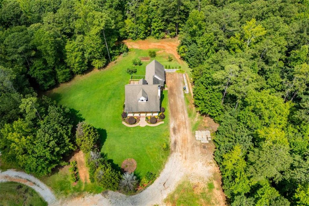 Welcome to your private countryside retreat! Nestled on 5.08 picturesque acres, this beautiful Cape Cod-style home offers the perfect blend of timeless charm, modern comfort, and peaceful seclusion. Boasting 4 spacious bedrooms and 3.5 bathrooms, this well-maintained home features a thoughtfully designed layout with abundant natural light, hardwood floors, and custom touches throughout. The main-level master suite provides a serene escape with a luxurious en-suite bath and generous closet space. The open-concept eat in kitchen is ideal for entertaining, flowing seamlessly into the living and dining areas, it creates a warm, inviting atmosphere for family gatherings or quiet evenings at home. Enjoy your morning coffee on the rocking chair front porch, take in sweeping views from the back deck, or explore your very own 5+ acres of rolling hills, mature trees, fruit trees and open fields-ideal for gardening, recreation, or simply soaking in the natural beauty. Additional features include: Cozy family room with fireplace, full basement including 1 bedroom & 1 full bath already finished and the potential for additional living space. The attached 2 car garage has ample storage & access to an unfinished room above that includes a pool table! Zoned for privacy yet just minutes to local amenities, schools, and commuter routes. Whether you're dreaming of a peaceful homestead, space to roam, or a home that combines style and space in perfect harmony, this Cape Cod is a must-see!