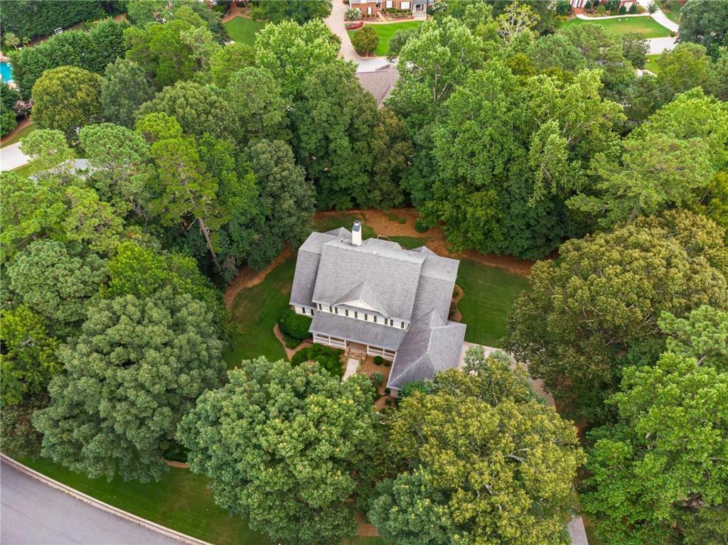 There’s a quiet confidence to this home—designed by noted architect Stephen Fuller—tucked into the heart of the Smoke Rise community, where the lots are large, the trees are mature, and the pace just feels a little more peaceful. At first glance, 2290 Spencers Way welcomes you with a timeless exterior and a deep, covered front porch that’s more than just charming—it’s where morning coffee becomes a ritual and evenings unwind with ease.
Step inside and you’ll sense how this home was intentionally crafted for both elegance and everyday living. The layout flows naturally, with formal rooms flanking the foyer that invite connection without sacrificing space. The two-story great room is bathed in light, centered around a classic fireplace and accented by a balcony above that gives the room its soaring feel. The adjoining kitchen and breakfast area overlook the deck and backyard, creating an ideal space for casual meals, weekend brunches, and late-night chats over a glass of wine.
While the floor plan is expansive, it also offers the kind of practicality that’s rare in homes of this size—like a private main-level primary suite and laundry, ideal for one-level living. Upstairs, there’s room for everyone and everything: four bedrooms (one ensuite), two full bathrooms, walk-in closets, and a generously sized bedroom that easily flexes as a second family room, home office, or guest retreat.
And then there’s the basement—an unfinished expanse full of potential. Whether you envision a movie theater, in-law suite, home gym, or game room, the space is yours to shape. It’s already framed with an ensuite, family room, and half bath in mind, making the groundwork for transformation that much easier.
The three-car garage provides plenty of space for vehicles, hobbies, and storage, while a newer roof and updated gutters mean some of the heavy lifting has already been done. What remains is the opportunity to personalize and polish—your way.
Located just minutes from Smoke Rise Country Club and the evolving charm of downtown Tucker, you’re never far from tennis matches, golf games, good meals, or the quick commute into Atlanta. Plus, with nearby parks and several routes in and out of the city, adventure and convenience are always within reach.
Homes like this—ones with good bones, soul, and space—don’t come along every day. Especially not in Smoke Rise. If you've been searching for a home with character, land, and the freedom to make it your own, this may be the one worth moving on.
Schedule your private tour today—and imagine what your next chapter could look like at 2290 Spencers Way.