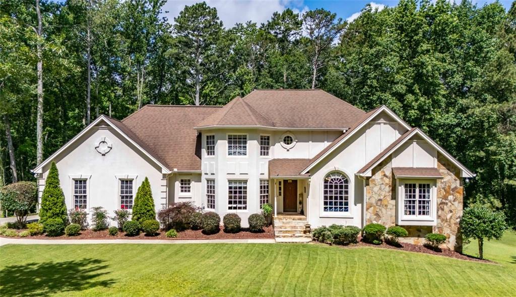 Stunning is just the beginning! This one has it all! This is a very large home on almost 3 acres! This is a rare find in this area! You have your own gated entrance, and lots of privacy with walking trails and your own creek in the back. Once you arrive you will truly experience the feel this home gives. Master on main, bedrooms upstairs with a massive entertainment room. You also have lots of space with full finished basement that would be an awesome in-law suite that includes a workout space and workshop. This home has so much space! There is a large deck on the back with a gorgeous view of the private fenced back yard. So many great things to say about this home! Location is incredible, minutes from everything!You're minutes from Fairburn with Durham Lakes Golf and Country Club next door! Don't miss this amazing opportunity!