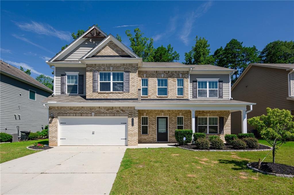 This charming two-story home offers a perfect combination of space, style, and location. Situated in the highly sought-after Sycamore Creek neighborhood, this home is ideal for families looking for comfort and convenience. Brick-front exterior with inviting covered porch, Bright and open layout with All hardwood floors throughout the main level, Elegant formal dining room with wainscoting and crown molding, Spacious living room with cozy fireplace and large windows, Modern kitchen featuring granite countertops, stainless steel appliances, tile backsplash, and a center island, Upstairs loft – perfect for a home office, study area, or media room, Laundry room with washer and dryer included, Private, fenced backyard with patio — great for relaxing or entertaining, Quiet, sidewalk-lined community with mature trees and well-kept homes, Just minutes from Lake Lanier, George Pierce Park, and the Suwanee Creek Greenway, Close to Sugar Hill Town Center – enjoy local shops, dining, and events