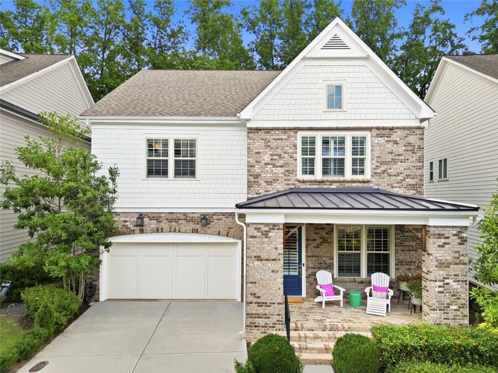 Welcome to 3006 Eamont Terrace! Brick and white shake siding exterior featuring a covered front porch with a metal roof