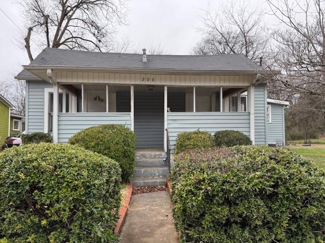 Bungalow with a porch and roof with shingles