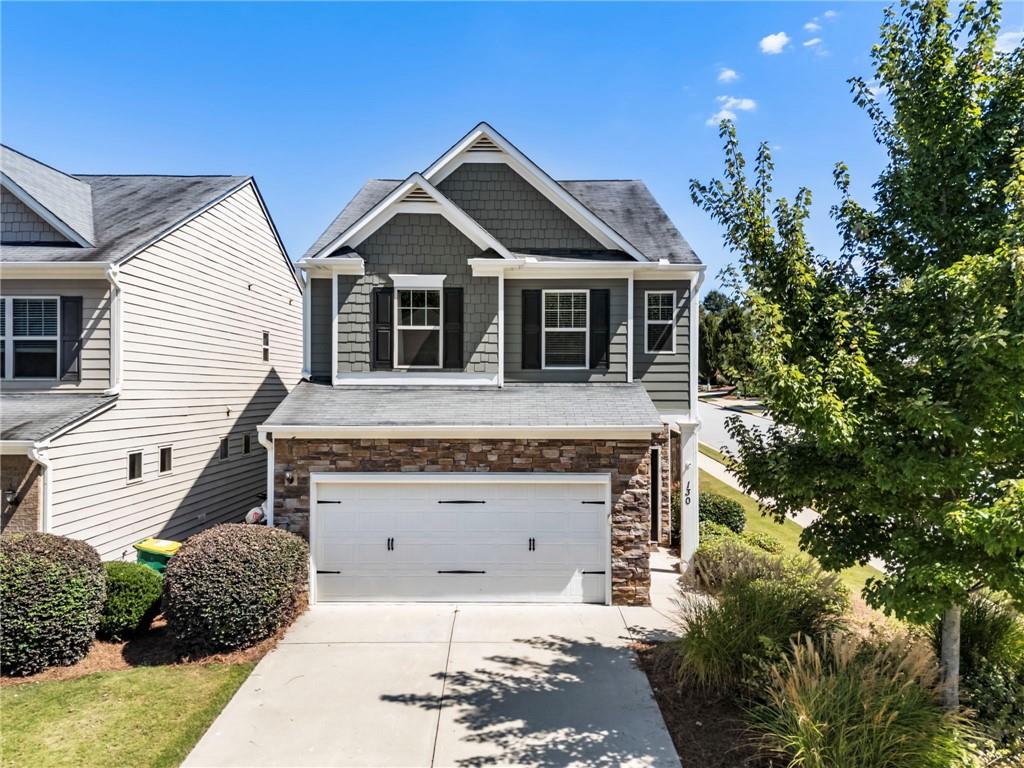 Beautifully maintained 3-bedroom, 2.5 bath home on a corner lot in the desirable Woodstock Village community. Recent updates include a new split HVAC system, fresh interior and exterior paint, new carpet on the stairs and second floor, and an updated half bath. The open floor plan features espresso hardwood floors, granite countertops, crown molding, stainless steel appliances, and white cabinetry. The spacious owner’s suite offers a sitting area, tray ceiling, walk-in closet, double vanity, soaking tub, and separate shower. Enjoy a private, fully fenced backyard with brand-new sod — ideal for kids, pets, or weekend gatherings. Woodstock Village is a kid-friendly, low-maintenance community with lawn care included and tons of neighborhood events. Conveniently located with easy access to Hwy 92, I-575, and GA-400, and just minutes from Downtown Woodstock, Roswell, shopping, and dining.