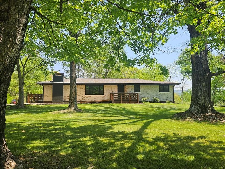 A Dream Home with Modern Amenities and Scenic Views. 
Nestled in picturesque west Pickens County, this exquisite property is ideally located just 15 minutes from Publix.  While the original home was built in 1968, the only original features are the exterior brick and the roof trusses (and they have been strengthened).  This beautifully remodeled mid-century home sits on a sprawling 1.5-acre quiet corner lot, surrounded by majestic old-growth oak trees, providing a serene park-like setting. The house has been completely revamped, and there is not a single step anywhere inside or outside of the house. The main hallway inside is extra wide, and the master bathroom has a walk-in shower.  Every inch of the plumbing and wiring has been replaced, 12-gage wiring has been used throughout the house, providing peace of mind and functionality for the new homeowners. New solid core doors were installed all through the home. One of the standout features of this property is the long-distance views of the mountains. The expansive double-entry driveway is all brand-new concrete without a single crack anywhere.
The kitchen boasts stunning quartz countertops that not only enhance the beauty of the space but also offer durability and low maintenance. Equipped with top-of-the-line brand-new appliances including Bosh Microwave and Dish Washer, LG Refrigerator. this kitchen is a chef's paradise, making cooking a delightful experience. The kitchen features custom high-end white cabinets that add both style and ample storage space. Brand new Anderson Windows have been installed throughout. Both bathrooms in the house are completely remodeled with modern fixtures and finishes, offering two spa-like retreats within the home.
This property also includes a remodeled detached garage equipped with an electric car outlet and workshop-style electrical outlets all around the perimeter.
This home is a perfect blend of luxury, comfort, and natural beauty, making it an ideal choice for those seeking a high-end lifestyle in west Pickens County.