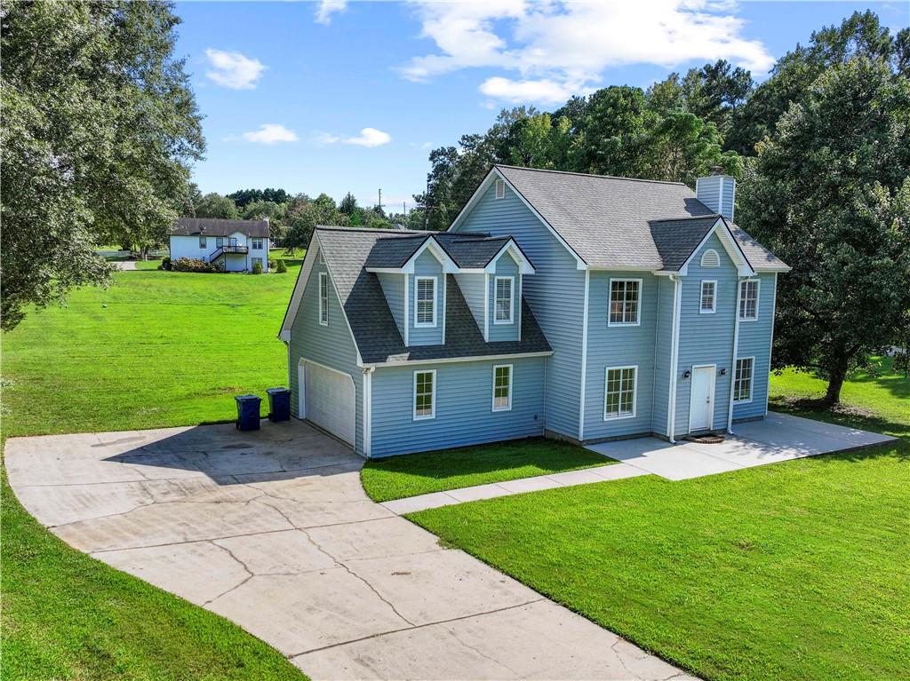 Welcome to 1201 Saint Andrews Drive in charming Auburn, GA! This beautifully maintained 3-bedroom, 2.5-bath home sits on a spacious 0.83-acre corner lot and offers nearly 2,000 square feet of comfortable living space. Inside, you'll find an inviting layout featuring hardwood floors, a cozy brick fireplace in the living room, and a light-filled dining area. The kitchen offers good space and flows into a casual breakfast nook. One of the standout features is the versatile bonus room, perfect for a playroom, home office, or guest bedroom, giving you the flexibility to adapt the space to your needs. The generously sized bedrooms offer peaceful retreats, while the updated bathrooms add a modern touch. Step outside to enjoy a large, private backyard ideal for entertaining, gardening, or simply relaxing. With a 2-car garage, dedicated laundry room, and fantastic location, this home checks all the boxes for comfortable, flexible living.