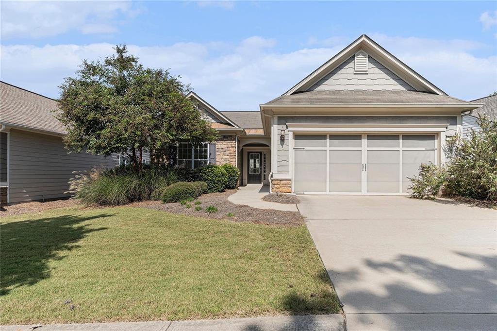 A beautiful craftsman style ranch home available and located in the desirable Sun City Peachtree community. As you step through the front door, you are greeted by a spacious foyer that sets the tone for the entire home. The open concept includes the living room, dining room and kitchen making it ideal for intimate gatherings. Living room with wood flooring and a corner fireplace, large dining area and open kitchen including granite countertops, stainless steel appliances, a large pantry and plenty of cabinets. A cozy sunroom leads outside to a covered porch for relaxation. The primary suite is a spacious retreat with an ensuite bathroom featuring dual vanities, a soaking tub and separate shower. Large walk-in with custom shelving. Second bedroom with easy access to hall bath. Large laundry room with cabinets and sink leading to the 2-car attached garage. Freshly painted throughout making it move in ready. Don't miss out on this gem. Call today and schedule your showing!