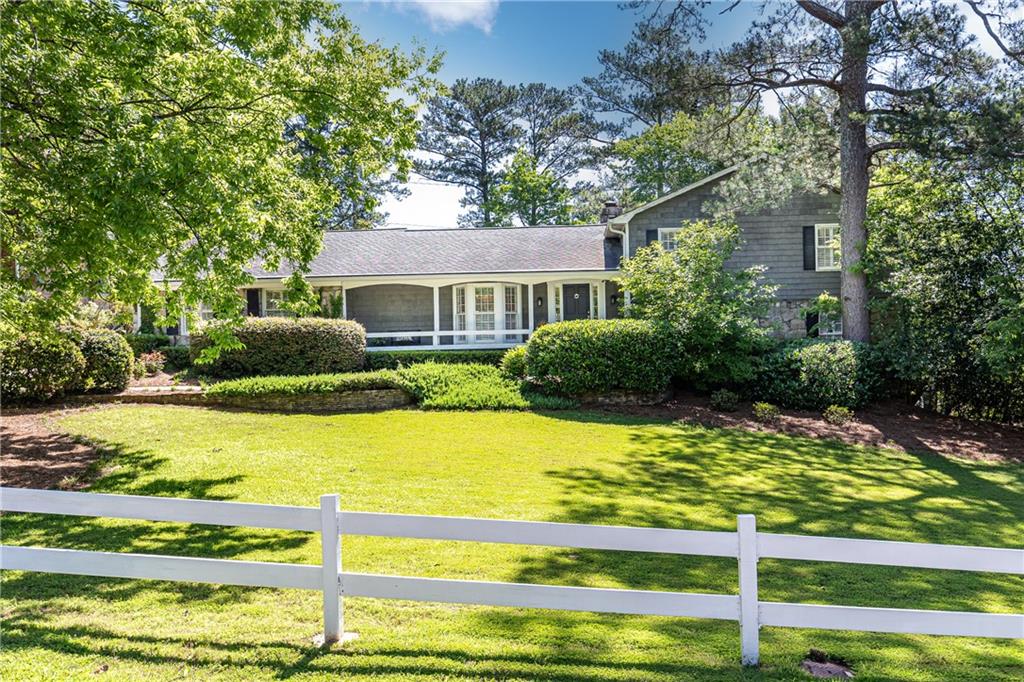 Welcome to this classic Cape Cod home, a rare gem nestled on one of Vinings’ most beloved streets—Farmington Drive. Brimming with character, comfort, and history, this one-of-a-kind property was originally custom-built by its sole owner, showcasing craftsmanship and materials that reflect Georgia’s rich architectural heritage.
At the heart of its design is the stunning use of Stone Mountain granite, a timeless material quarried from the iconic Georgia landmark. Celebrated for its strength and natural beauty, this granite has graced many of the state's most notable structures. Its presence in the home not only elevates the aesthetic appeal but also serves as a lasting tribute to regional pride and enduring craftsmanship.
Inside, you'll find an elegant and spacious layout filled with thoughtful details: four fireplaces, floor-to-ceiling built-in millwork, a hidden butler’s pantry, and abundant closet and storage space—all adding sophistication and functionality throughout.
Step outside to enjoy beautifully appointed outdoor living areas, including a generous swimming pool and a charming pool house with a half bath—perfect for entertaining or unwinding in privacy. Beyond the pool and carport, the expansive property line stretches much farther than meets the eye, offering exceptional potential for additional landscaping, gardens, or custom outdoor features to suit your vision.
This is more than just a home; it’s a legacy. Don’t miss the opportunity to own a true Vinings classic on one of its most cherished streets.