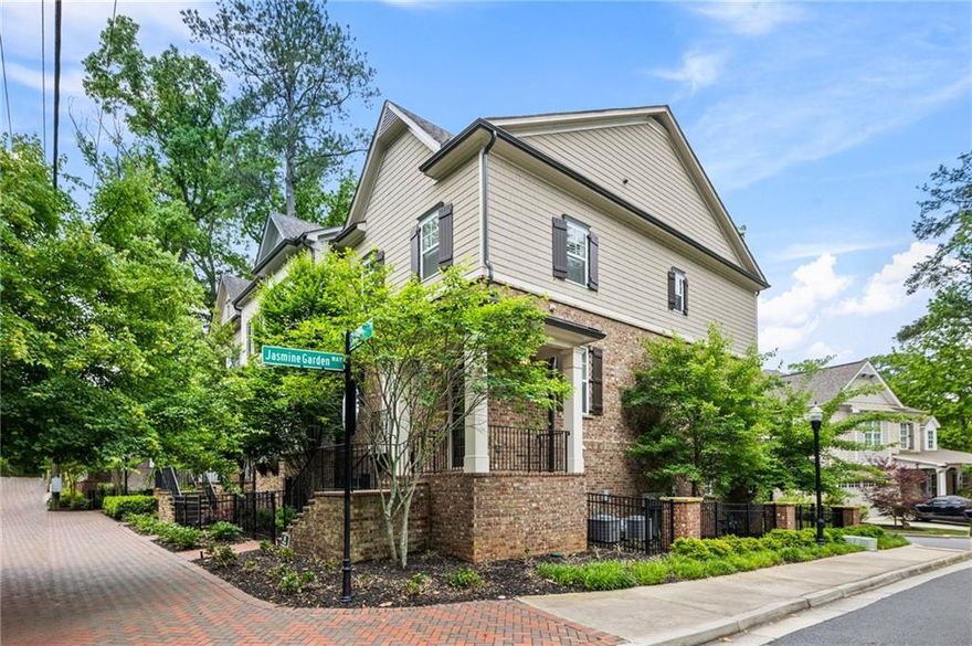 Located in the heart of Downtown Alpharetta, this stunning end-unit townhome offers luxury, convenience, and beautifully maintained interiors. Filled with natural light, the open floor plan is perfect for both daily living and entertaining. The home is just steps from Canton Street, close to restaurants, boutiques, and Wills Park.

Professionally decorated and upgraded throughout, the freshly repainted interior creates a bright, cohesive backdrop. The kitchen features refinished cabinetry, updated Kohler hardware and fixtures, and Glide-Out shelves by ShelfGenie for optimized storage. A remodeled powder room, updated drop zone, and a fireplace with new surround and mantle add style and function.

Hardwood floors, plantation shutters, custom closet systems, and a Phoenix security system with cameras enhance the home’s thoughtful design. The garage includes an epoxy-coated floor, built-in storage cabinets, a quieter door system, and a dedicated 220-volt outlet for EV charging.

Upstairs, two oversized bedrooms each offer en-suite baths, while a lower-level bedroom is ideal for guests or a home office. A dedicated computer nook and mudroom from the two-car garage provide everyday convenience. Extra guest parking, a landscaped park, and maintenance-free living complete this exceptional property. Immaculately cared for and barely lived in, this home shows like a model.