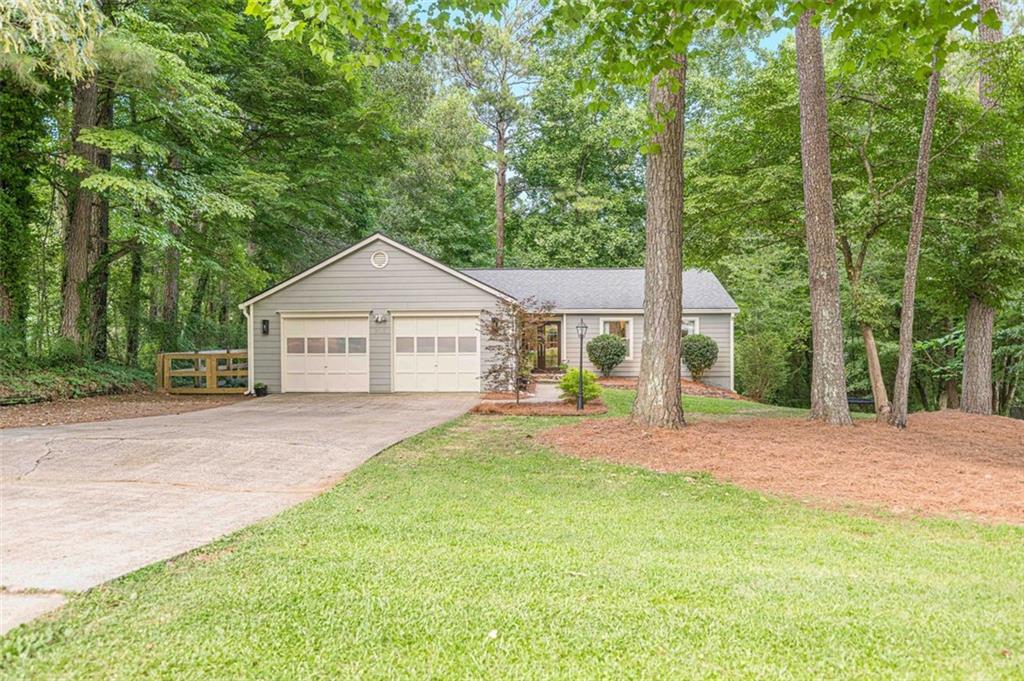 Renovated 4BR/2BA Ranch with Designer Finishes in Prime Woodstock Location with NO HOA!
Tucked at the end of a quiet street, this beautifully renovated 4-bedroom, 2-bathroom ranch on a basement offers modern upgrades, custom finishes, and peaceful surroundings just minutes from Downtown Woodstock and top-rated schools.
The fully remodeled kitchen features quartz countertops, custom cabinetry, a gas oven, tile backsplash, and under-cabinet lighting. The open layout includes a separate dining room, breakfast area, and a spacious living room with a stunning electric fireplace wall and shiplap accents. LVP flooring runs throughout most of the home, with tile in the bathrooms and carpet in the bedrooms.
The primary suite boasts a luxurious six-foot walk-in shower with dual shower heads, heated floors and bidet. A flexible bonus room serves perfectly as an sunroom, office, playroom, or sitting area. The main level also includes a laundry room for added convenience.
Upgrades include new windows, a new double front door, new exterior paint, new insulation, a new water heater, and a heated garage—one side converted into a home gym. Outdoor living shines with nearly 1,000 sq ft of deck space, a brand-new lower deck, fenced-in side yard, privacy trees, landscape lighting, and a custom-built bridge over the backyard creek.
Located near the upcoming Little River Park on Trickum Rd, you’ll soon enjoy trails, aquatic features, playgrounds, and more just moments from home.
This move-in-ready home is full of character, comfort, and quality—come see it today!