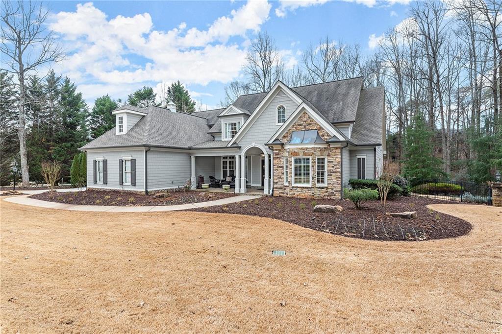 Exquisite home in the coveted White Columns golf section! Private, level lot with custom gunite Pebbletec pool and spa is ideally situated just moments from the country club amenities. As you enter the home through the oversized, charming front porch, you will immediately appreciate the refinished hardwood floors, the substantial dining room, and the two-story foyer that leads to a light-filled living room with a fireplace. The gorgeous main-level primary suite has an updated bathroom featuring marble countertops, floors, and surround, a new soaking tub, a steam shower, and two walk-in closets. The updated and improved gourmet kitchen has a one-level island, genuine Quartz countertops and backsplash, new soft close cabinets, and stainless-steel appliances, including a Wolf range and Subzero fridge. The farmhouse sink, plantation shutters, fireside keeping room, and added veggie sink, coffee bar, and wine cooler add to the ambiance in this entertainer’s dream. An enormous Trex deck runs along the back of the home and overlooks the private creek-lined backyard and Tennessee field stone-covered pool area. The Weather-proof dry below decking provides an equally charming entertaining space below on the terrace level that adjoins your luxurious swimming pool area. Whether you enjoy the peace and your beautiful view or entertaining family and friends, you are in for a pure delight! The fully finished terrace level can easily double as an in-law or au pair suite and includes a second kitchen, two eating areas, an additional bedroom, full bath, family room with fireplace, wine cellar, billiards room, gym, craft room/office, and easy access to the expansive outdoor entertaining space. All three secondary upstairs bedrooms are generously sized and have an en-suite and jack-and-jill baths with updates.  A large loft/office and a game room/flex room round out the top level of this fantastic home. Move-in ready and spectacular! Award-winning schools! White Columns Country Club offers various socializing, sporting, and exercising packages.  Please ask Kim, the listing agent, for details or pick up an info packet at the home when you visit.