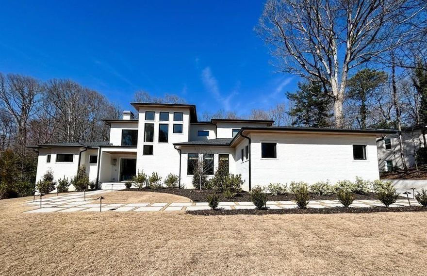 Can be ready by year end!!  Tucked away at the end of Mystic Drive, just a short walk to CHASTAIN PARK's premier trails, golf course, and dining, this custom new construction offers the perfect blend of privacy, functionality and refined design. The open-concept layout is built for effortless entertaining, with multiple indoor and outdoor gathering spaces, including an inviting covered porch/deck with a fireplace overlooking the level park like backyard & pool site along with a separate side porch featuring an outdoor kitchen/grilling station. The kitchen cabinetry is hand done by a local European woodworking craftsman and perfection! A separate scullery tucked behind sliding frosted glass doors showcases a beverage refrigerator, additional ovens, sink & 2nd dishwasher all this conveniently located between the kitchen and mudroom for out of the way meal prep or party help. Requiring a larger building footprint it is rare to find both a luxurious primary suite, as well as a second guest bedroom with a full bath on the main level.  The spa-like primary bath offers a sumptuous shower with 2 shower heads, a rain head and a handheld device as well as a relaxing soaking tub, double vanities with abundant storage and counter space and his & her oversized closets. The second bedroom offers versatility—perfect for guests, in-laws, a nursery, or a private office. At the heart of the home, a steel-and-glass wine room creates a stunning focal point, adjacent to a custom wet bar for seamless hosting. For added convenience, laundry rooms are located on both levels, making everyday living effortless. Upstairs, a spacious loft connects to three en-suite bedrooms and a flexible bonus space. The finished terrace level is flooded with natural light and offers another ensuite bedroom or private office space as well as an expansive main room with a wall of panoramic glass doors and also featuring a custom wet bar w/ refrigerator, dishwasher, ice maker and abundant cabinet space for all your entertaining needs. 2 additional oversize rooms flank each side of the main space allowing for exercise room, game room, media room or just overflow for family and friends gatherings. This level also features a walkout patio leading to a lush backyard with established hardwoods and a prime pool site. Additionally, The builder has installed a brand-new sewer line for seamless connection to public sewer so there are no septic tank worries or maintenance. Located in the coveted Riverwood International Charter School district, this is a rare opportunity to own a thoughtfully designed, high-end home in one of Atlanta's most desirable neighborhoods. A truly competitive price for New Construction of this caliber. We invite you to Come and see for yourself.
**Now available for private showings**