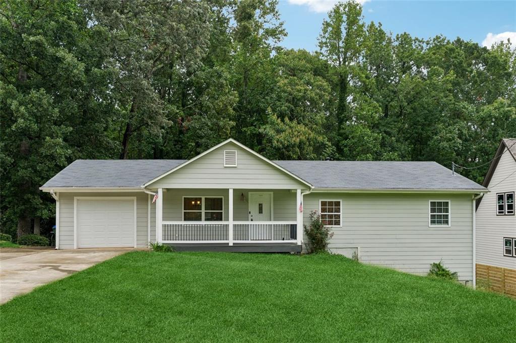 **Assumable Mortgage**. Fully renovated ranch-style home on a stunning lot in Gwinnett County! Enjoy the charming rocking chair front porch before stepping into the bright and inviting family room with beautiful hardwood floors. The open-concept kitchen boasts stainless steel appliances, granite countertops, a breakfast bar, and a cozy dining area. The primary suite offers a private bath, while two additional bedrooms share a stylishly updated second bathroom on the main level. A finished terrace level provides extra living space. Relax on the expansive back deck overlooking the generous backyard. Conveniently located near top-rated schools, dining, and shopping-with no HOA